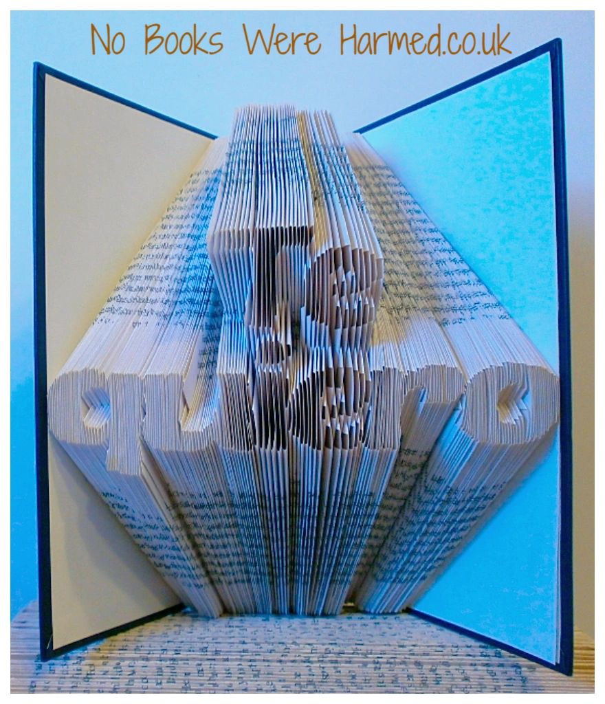 Hand-folded book art titled 'Te quiero', showcasing intricate designs from vintage books with unique colors and textures.