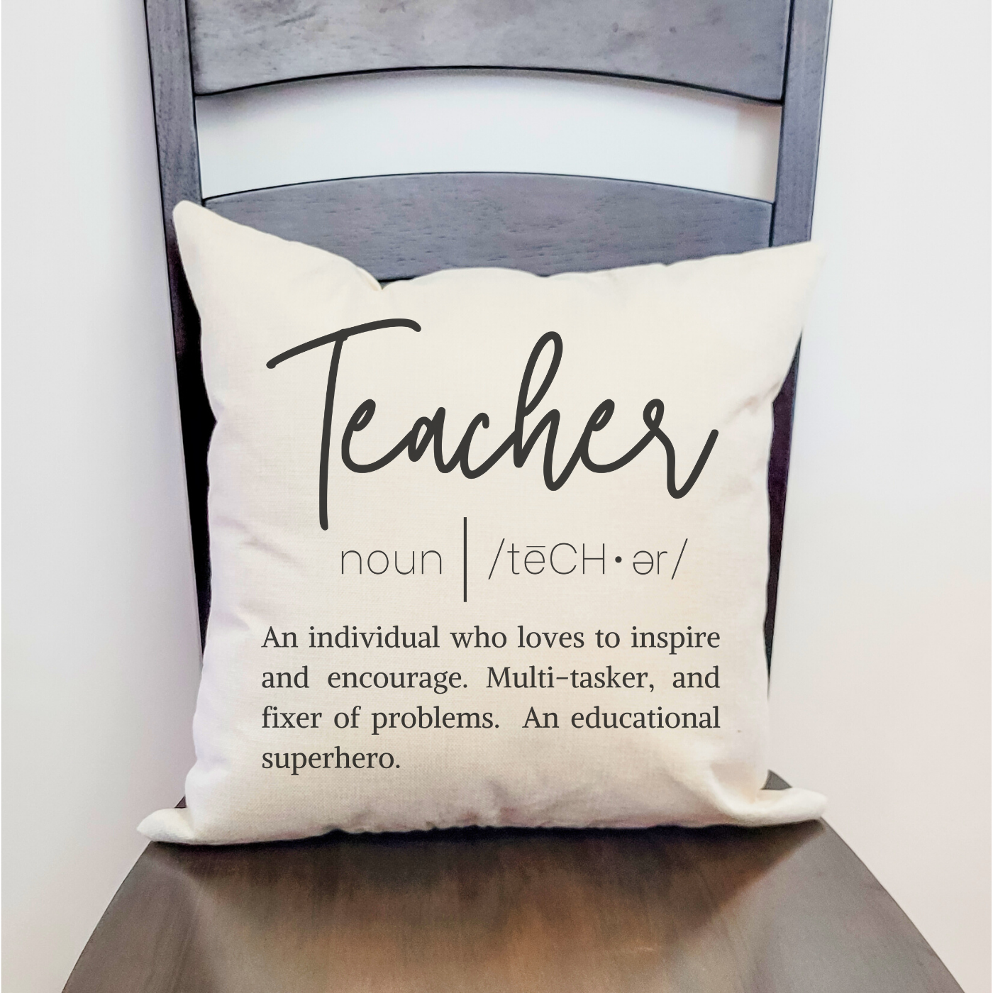 A cozy Teacher Definition Pillow Cover in Farmhouse Beige, measuring 18 x 18 inches, made from soft polyester linen.