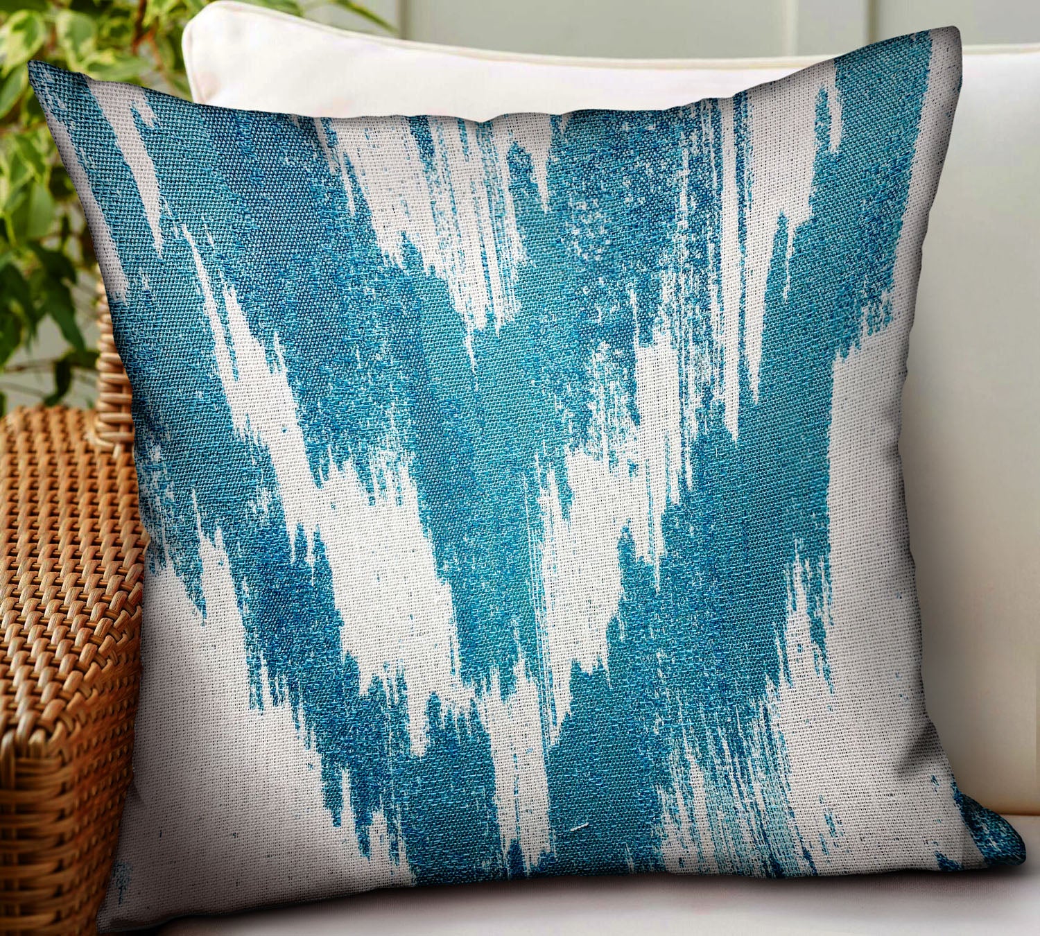 Teal Avalanche Blue Ikat Luxury Throw Pillow showcasing vibrant blue Ikat pattern, durable Sunbrella fabric, and invisible zipper closure.