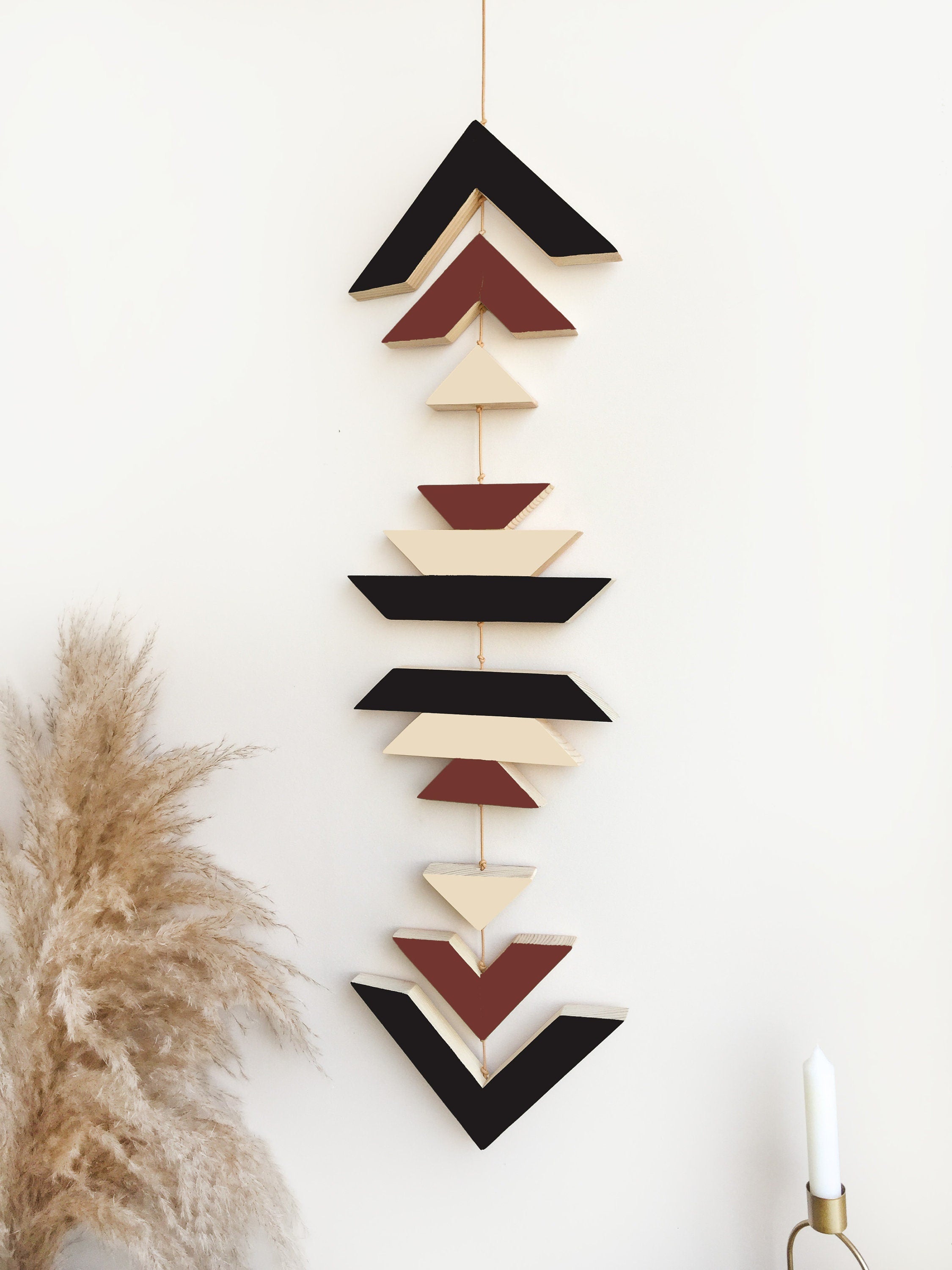 A beautiful Terra Wood Wall Hanging featuring earthy tones, perfect for boho decor, displayed against a white wall.