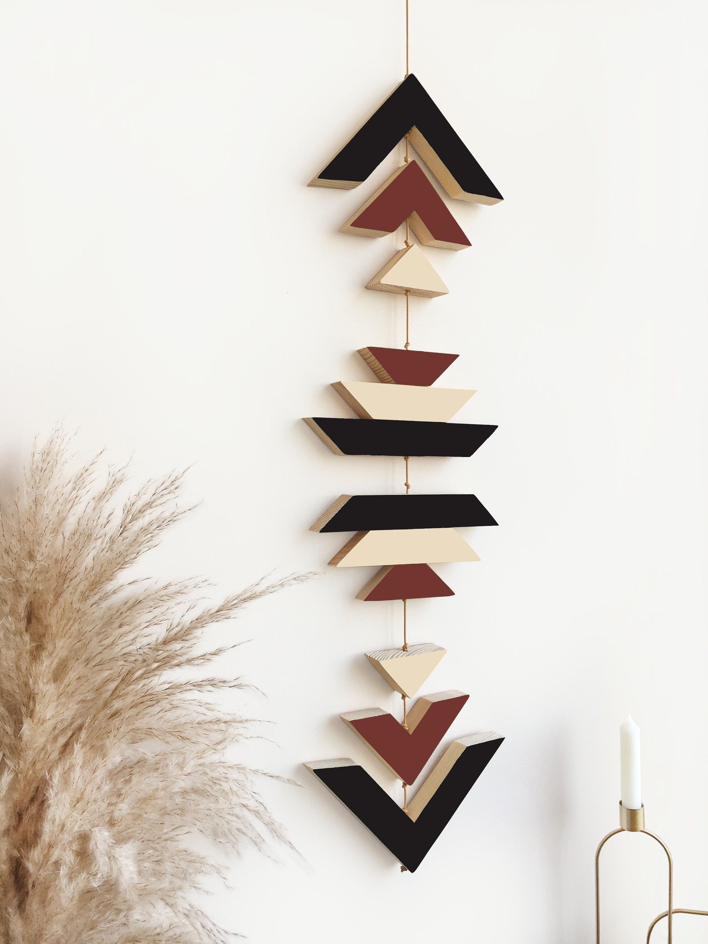 A beautiful Terra Wood Wall Hanging featuring earthy tones, perfect for boho decor, displayed against a white wall.