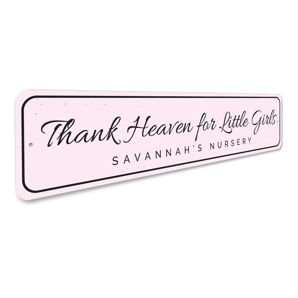 Decorative 'Thank Heaven for Little Girls' sign made of aluminum, featuring a charming design suitable for children's rooms.