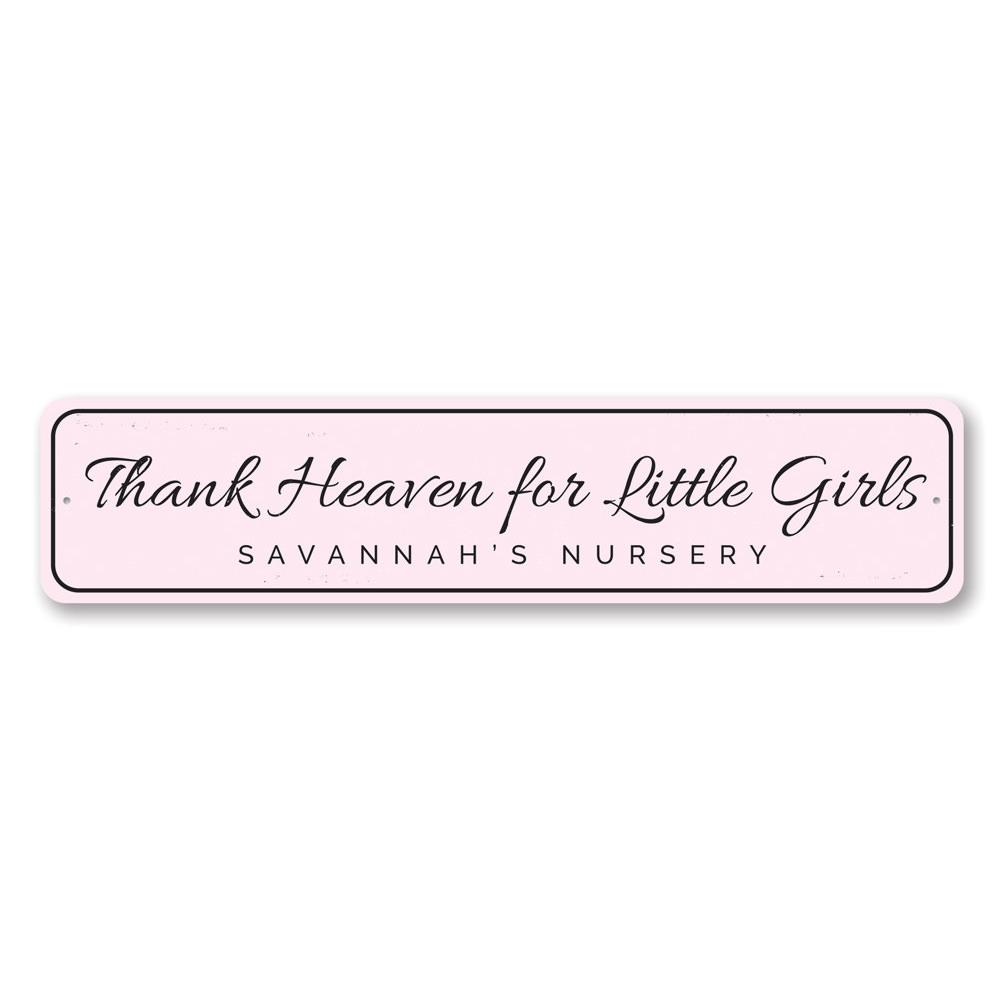 Decorative 'Thank Heaven for Little Girls' sign made of aluminum, featuring a charming design suitable for children's rooms.