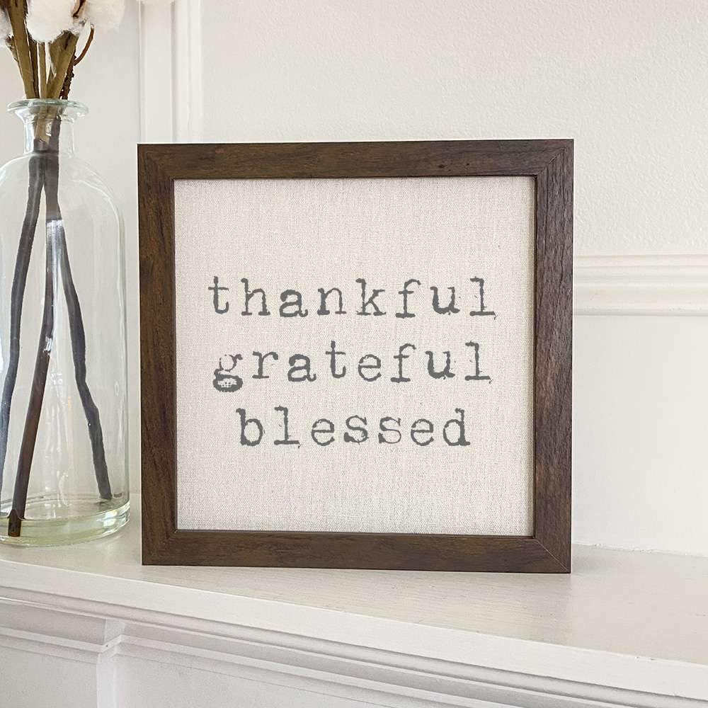 Thankful Grateful Blessed framed sign with a stylish wood frame and linen-look background, perfect for home decor.