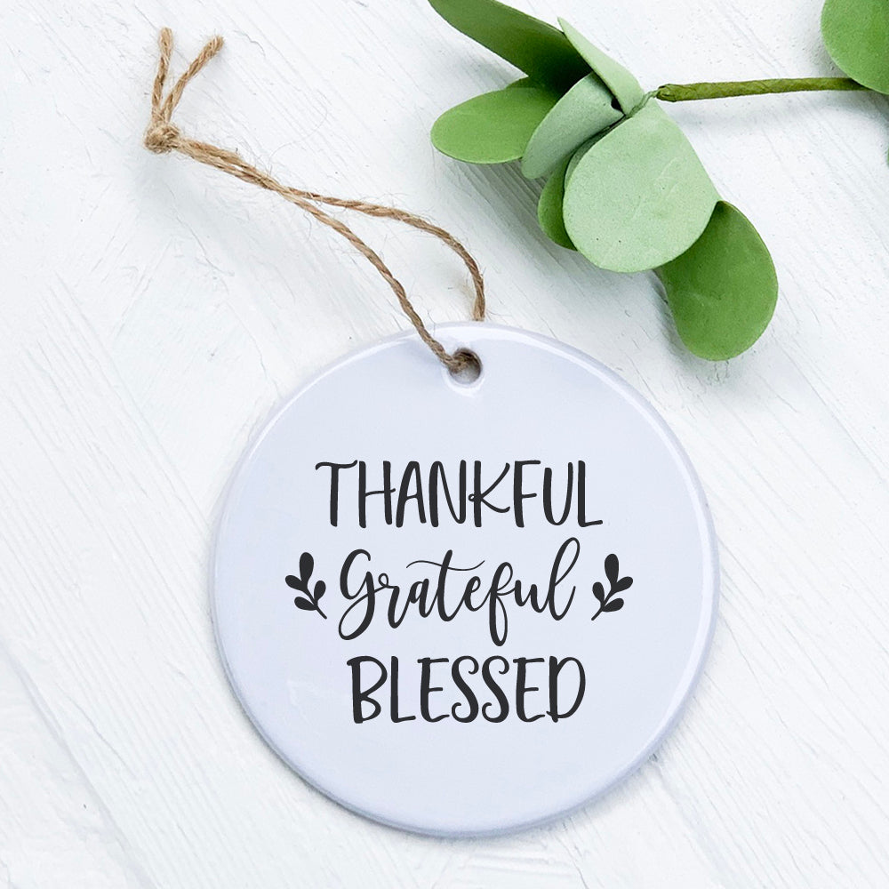 Thankful Grateful Blessed porcelain ornament featuring a smooth glossy finish and vibrant design, perfect for holiday decor or gifting.