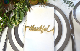 Set of 4 Thankful Matte Gold Napkin Wraps elegantly displayed in a stylish box.