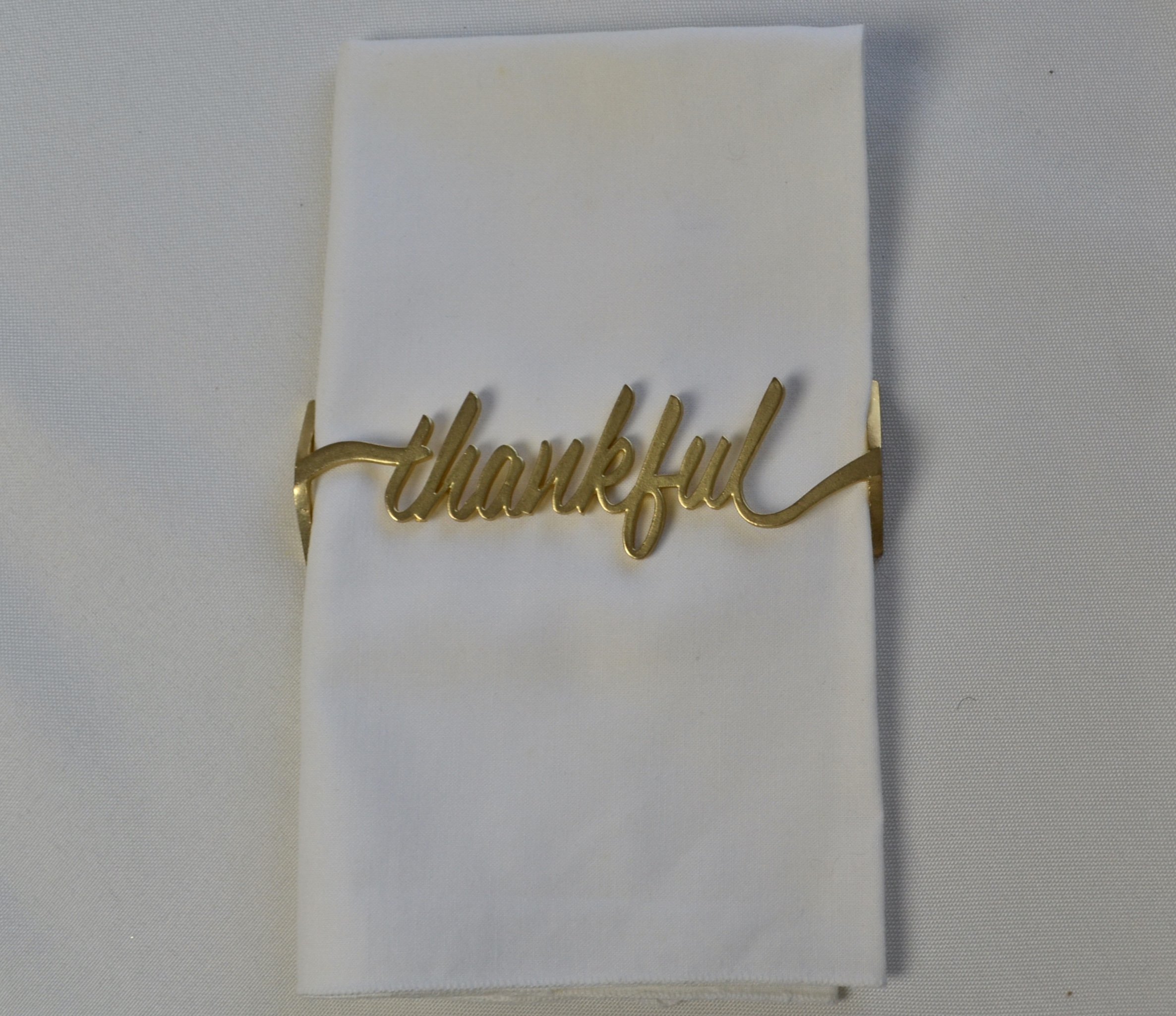 Set of 4 Thankful Matte Gold Napkin Wraps elegantly displayed in a stylish box.