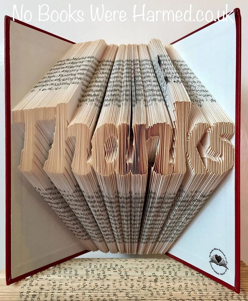 Handcrafted book art featuring the word 'Thanks' elegantly folded into the pages of a vintage book, showcasing unique design and craftsmanship.