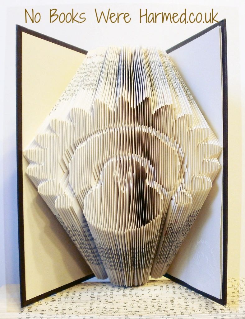 Handcrafted Thanksgiving Turkey art made from vintage books, showcasing intricate hand-folded pages in warm autumn colors.