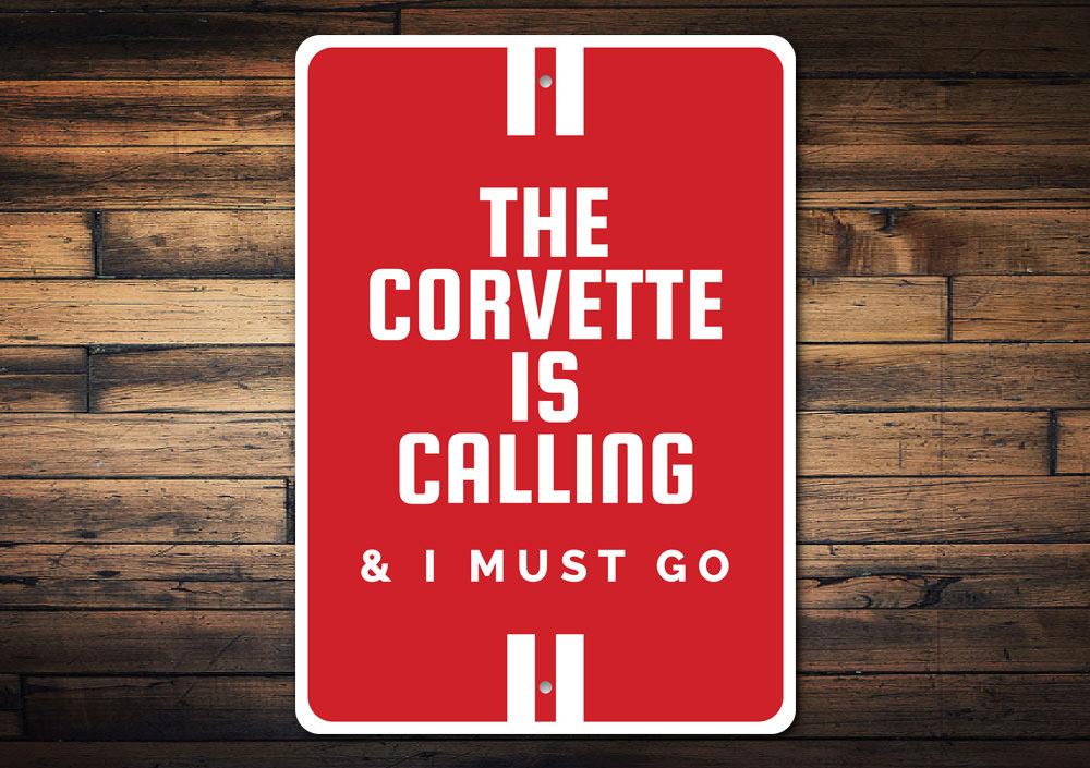 A vibrant aluminum sign featuring the text 'The Corvette Is Calling', showcasing a classic Corvette design, perfect for car enthusiasts.