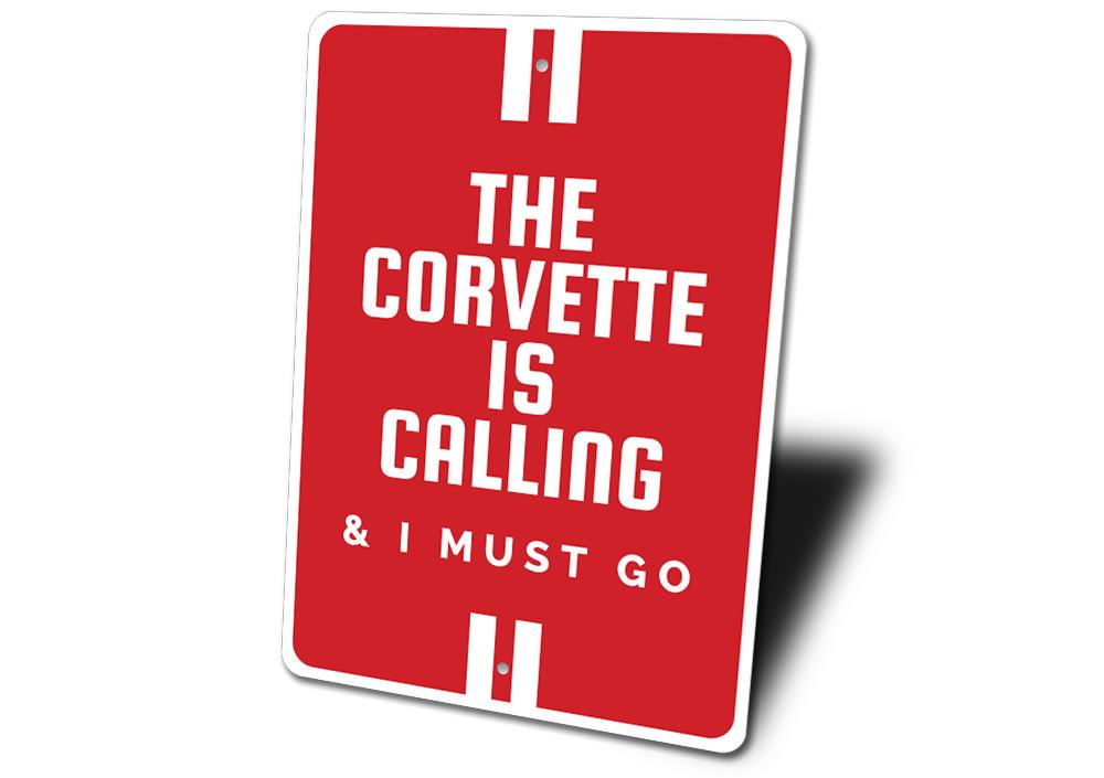 A vibrant aluminum sign featuring the text 'The Corvette Is Calling', showcasing a classic Corvette design, perfect for car enthusiasts.