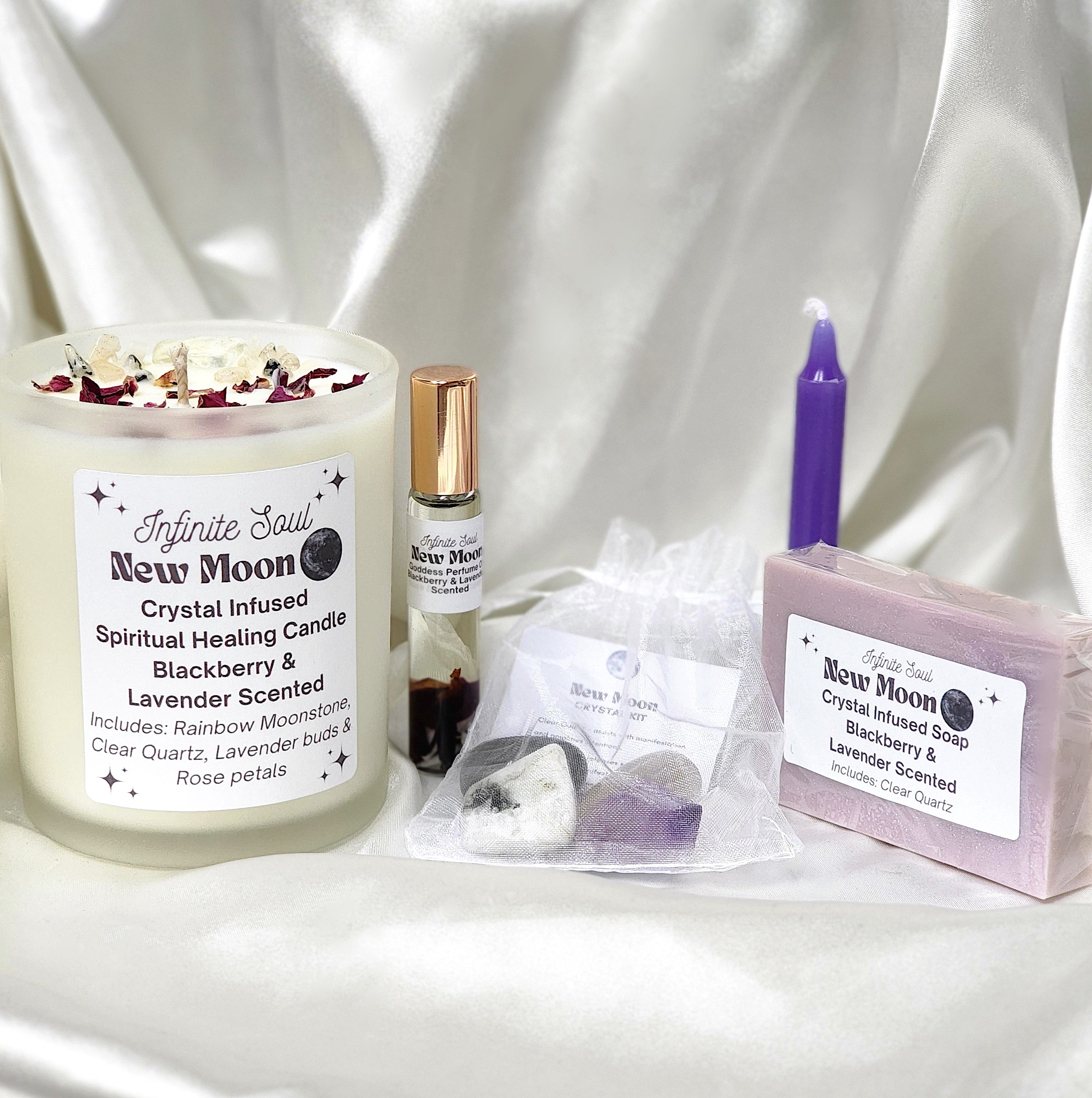 The Infinite Soul New Moon Bundle featuring a healing candle, body oil, crystal kit, soap, bracelet, and notebook, all designed for new moon rituals.