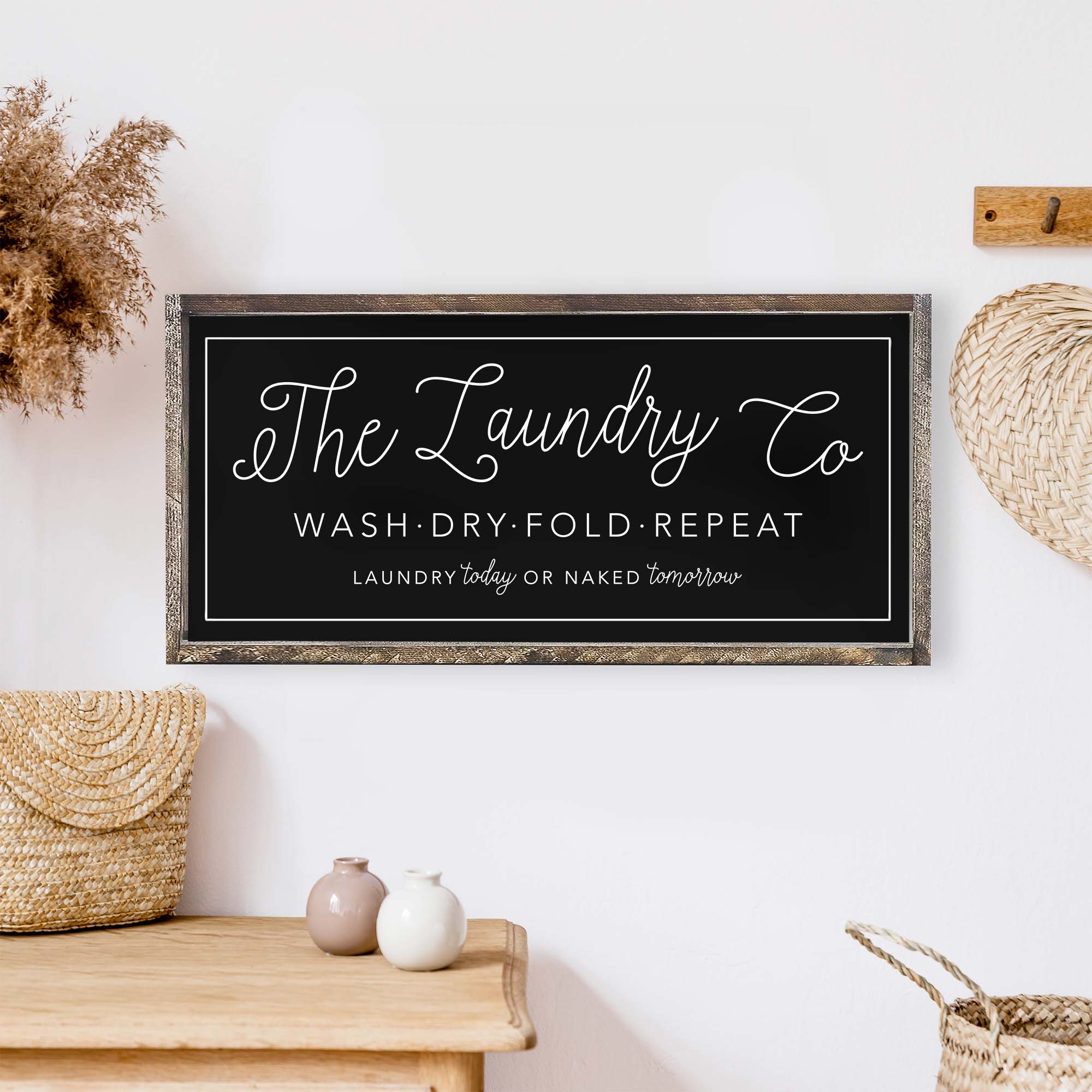 The Laundry Co Wood Sign featuring black and white text on a white background, framed in stained pine wood, perfect for laundry room decor.