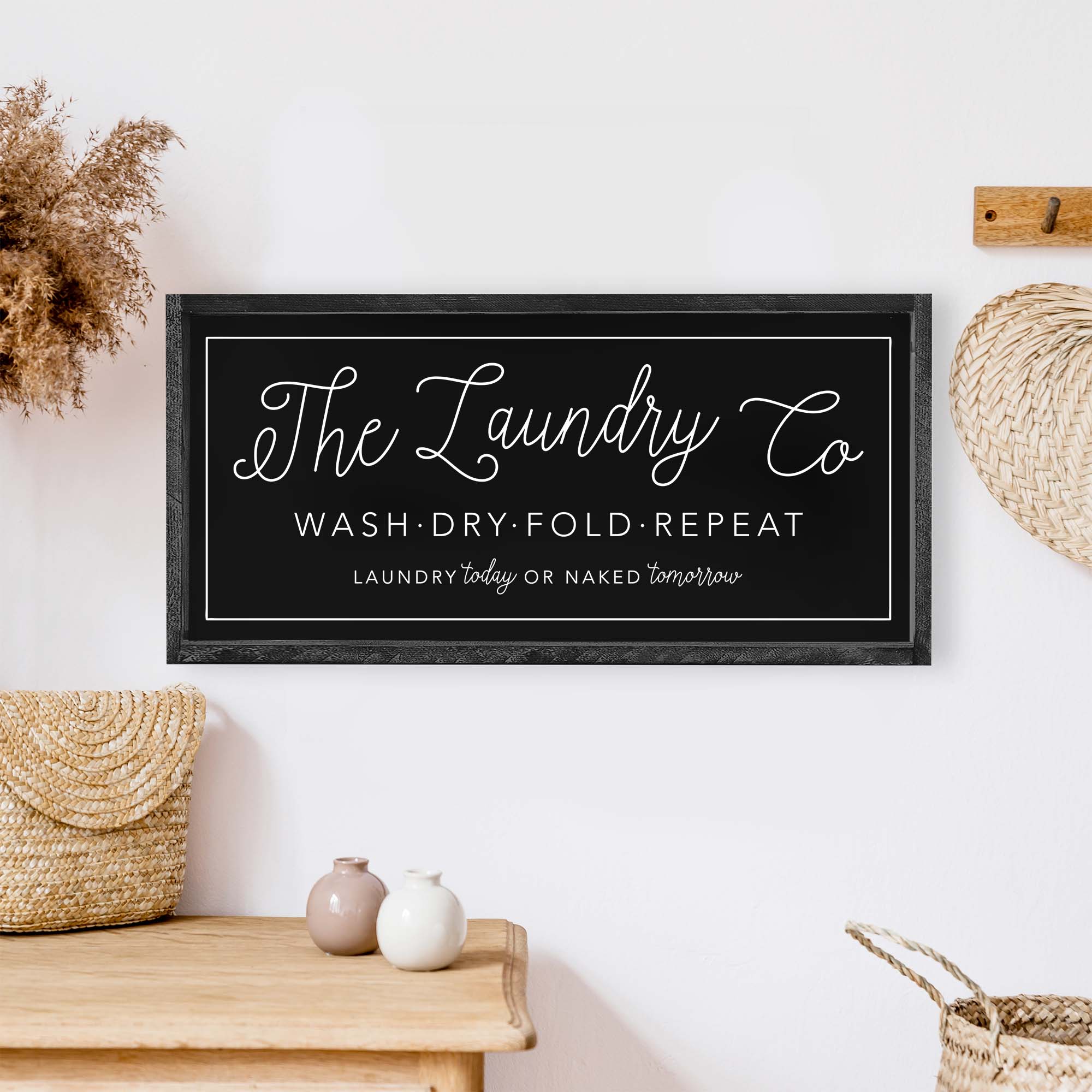 The Laundry Co Wood Sign featuring black and white text on a white background, framed in stained pine wood, perfect for laundry room decor.