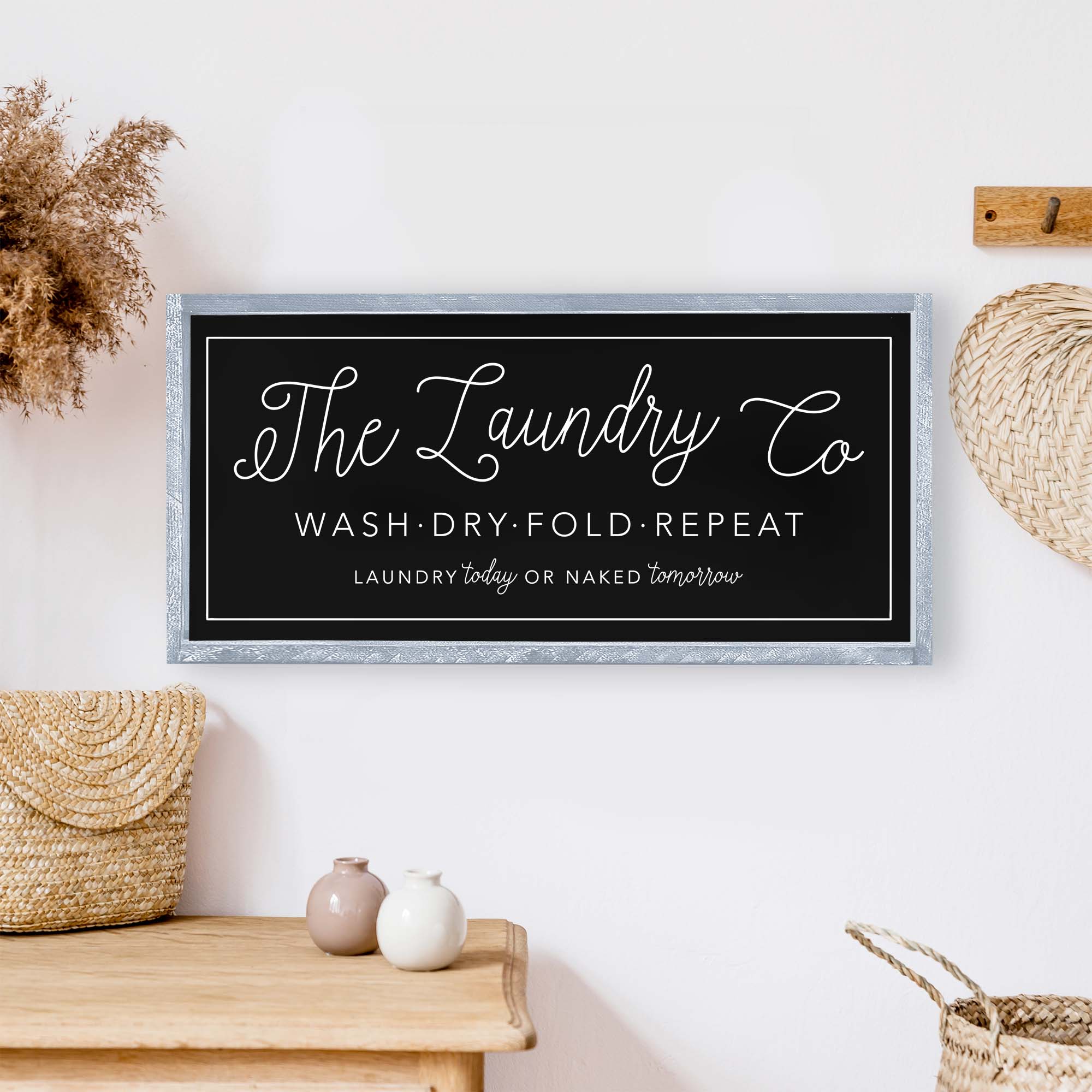 The Laundry Co Wood Sign featuring black and white text on a white background, framed in stained pine wood, perfect for laundry room decor.