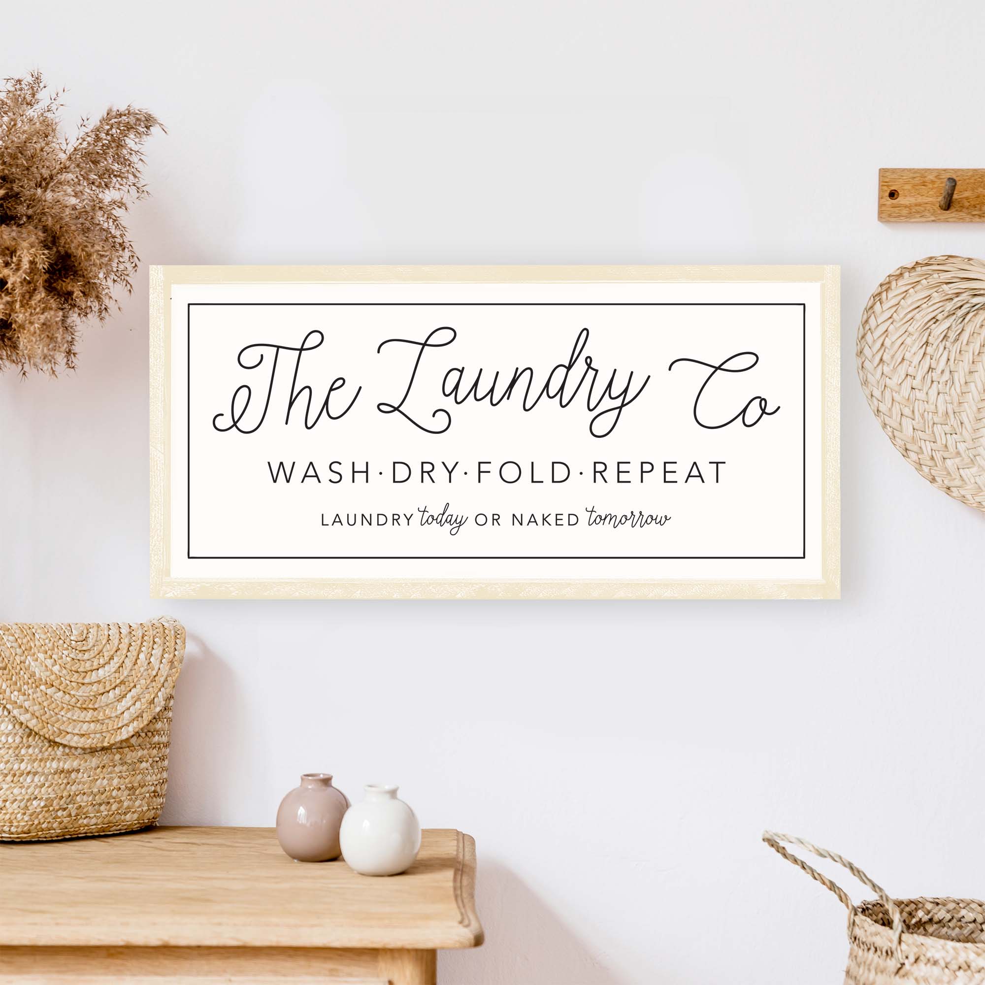 The Laundry Co Wood Sign featuring black and white text on a white background, framed in stained pine wood, perfect for laundry room decor.