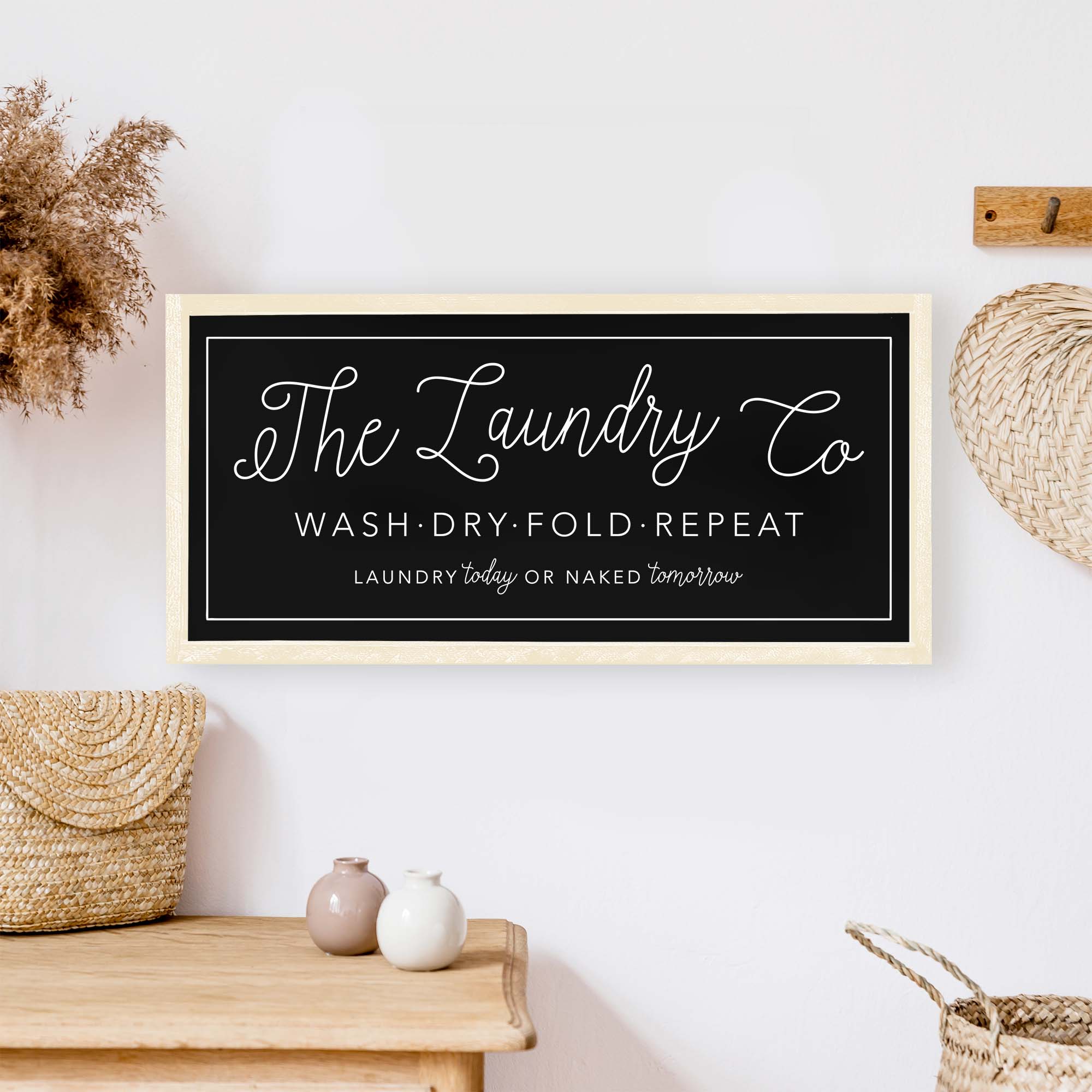 The Laundry Co Wood Sign featuring black and white text on a white background, framed in stained pine wood, perfect for laundry room decor.