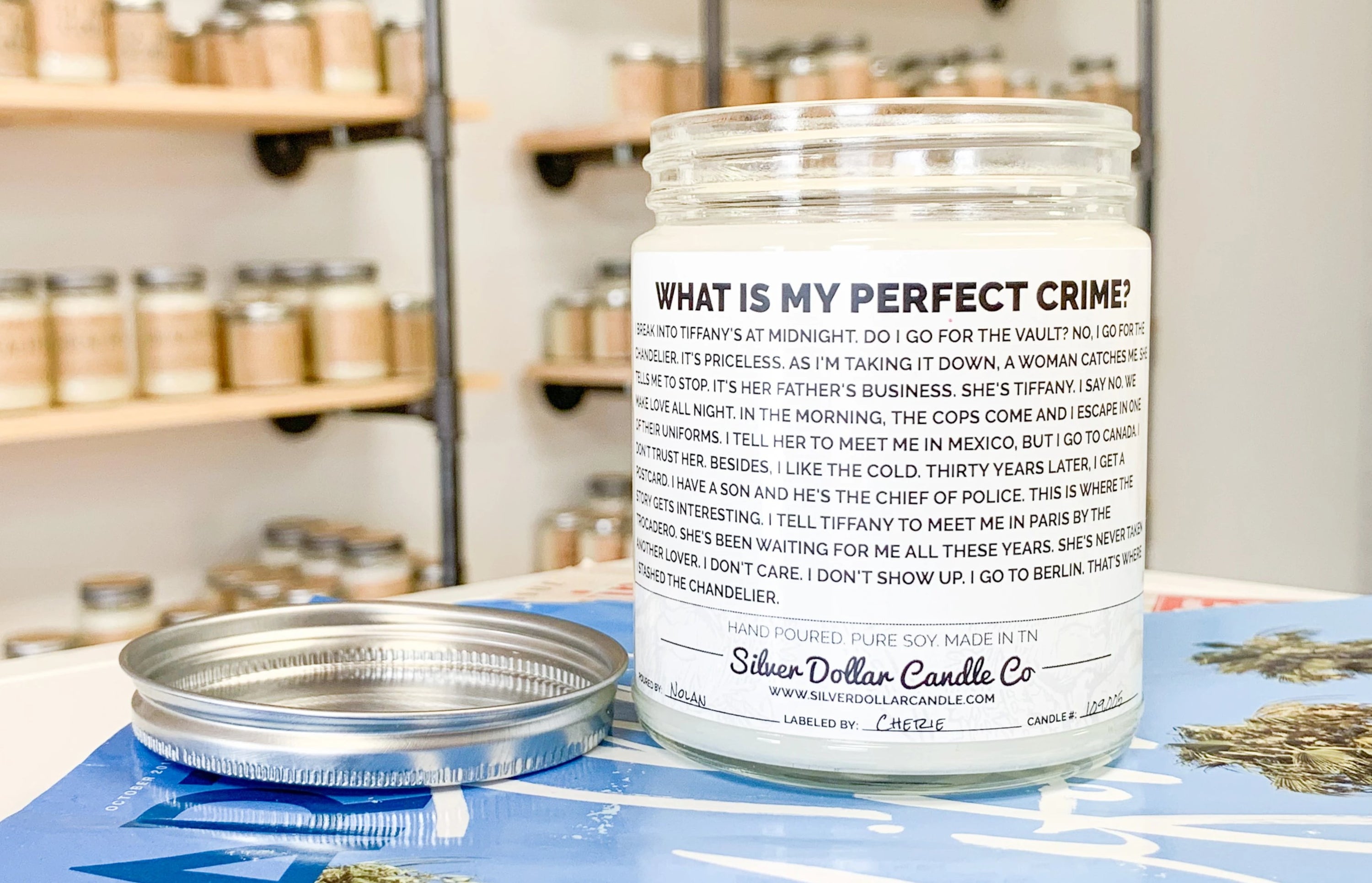 Dwight's Perfect Crime Candle featuring a humorous quote from The Office, presented in a stylish jar with a personalized lid option.