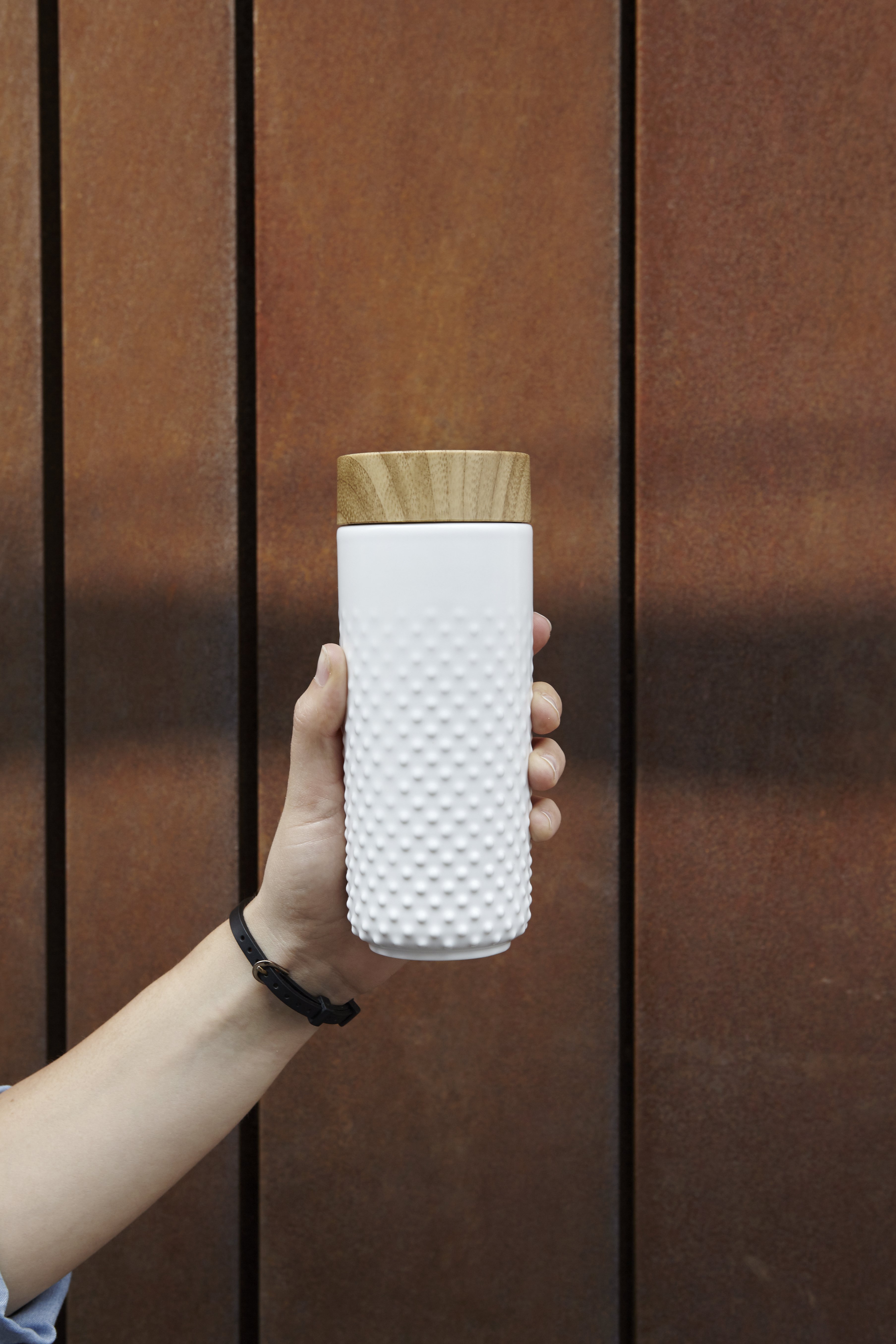 Ceramic double-wall water bottle with a starry night design, featuring raised stars and a sleek bamboo effect lid.