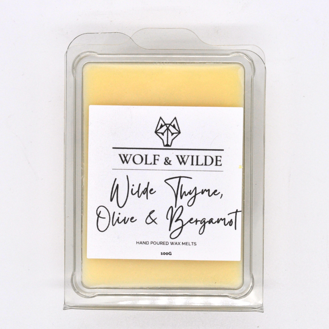 Thyme Olive & Bergamot Soy Wax Melts in a decorative dish, showcasing vibrant colors and a fresh citrus aroma.