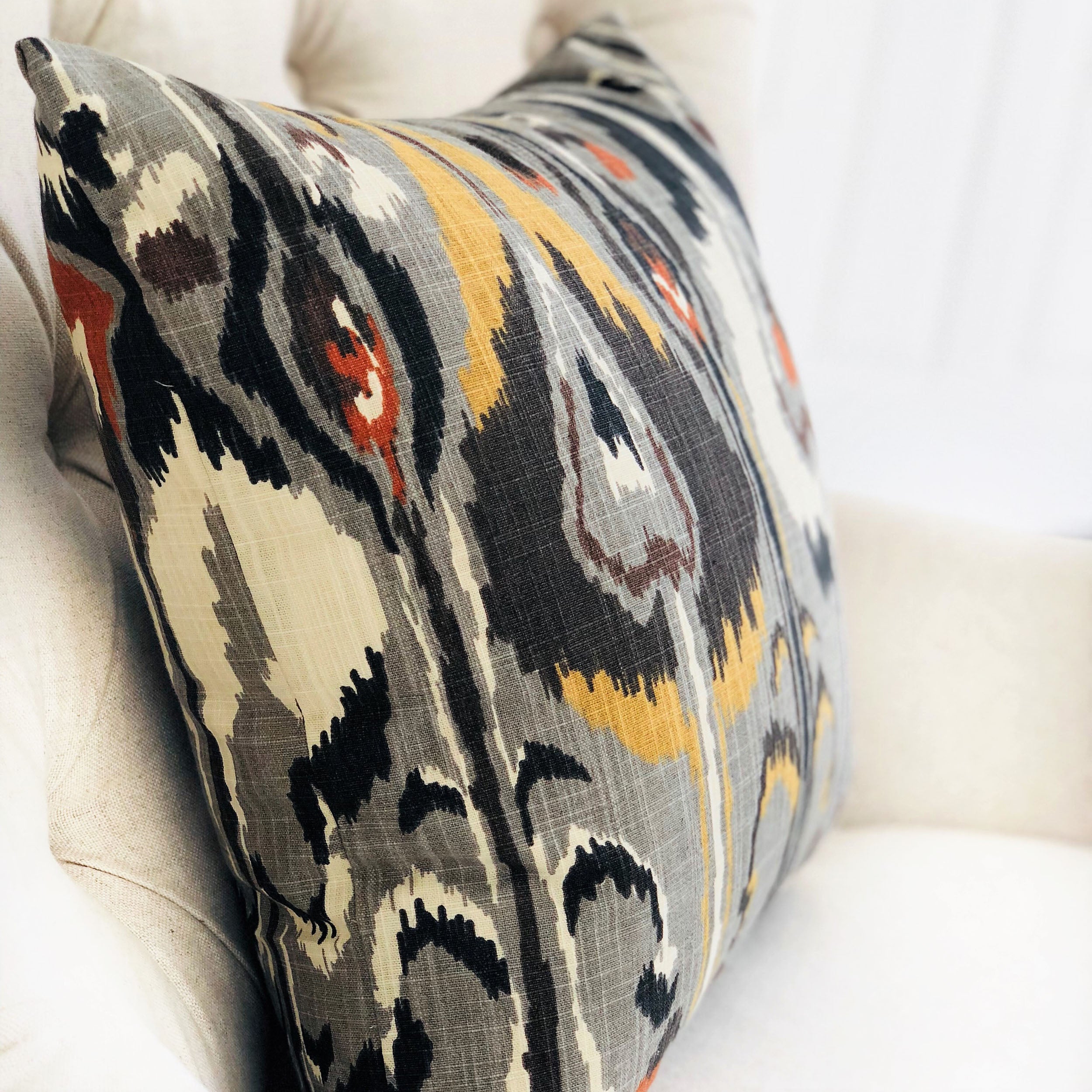 Tigerlily Gray Luxury Throw Pillow featuring a chic Ikat pattern, handmade in the USA with a soft cotton fabric and invisible zipper.