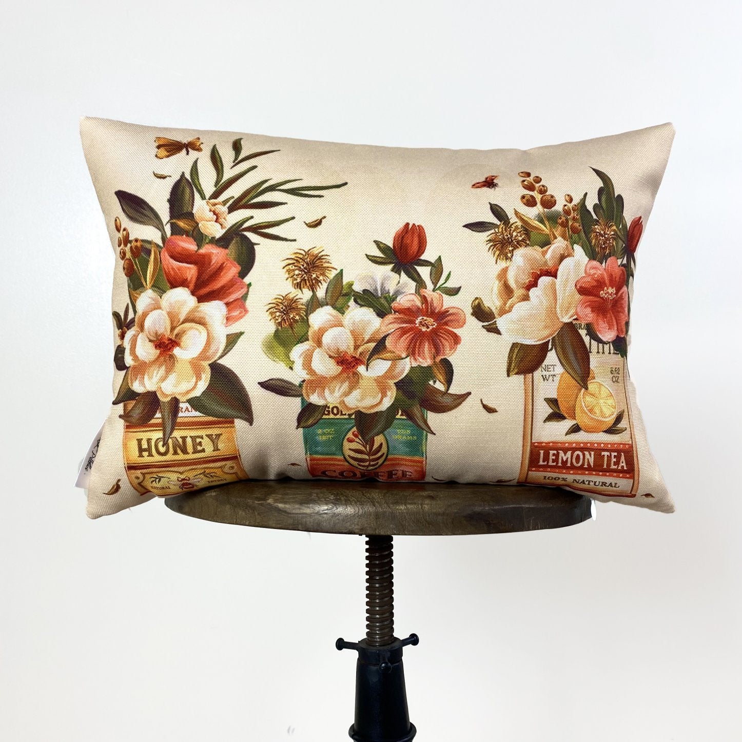 A beautifully crafted Tin Floral Arrangement pillow cover featuring vibrant watercolor flowers on a vintage tin design, with a concealed zipper.