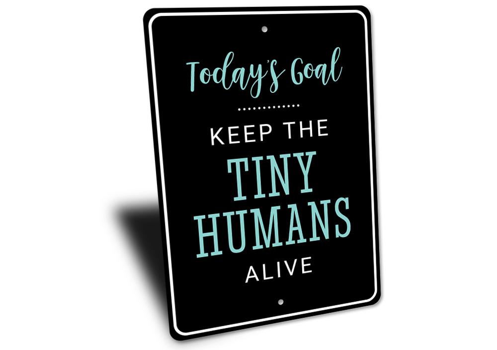 A decorative Tiny Humans Sign made of high-quality aluminum, featuring customizable text and pre-drilled holes for easy mounting.