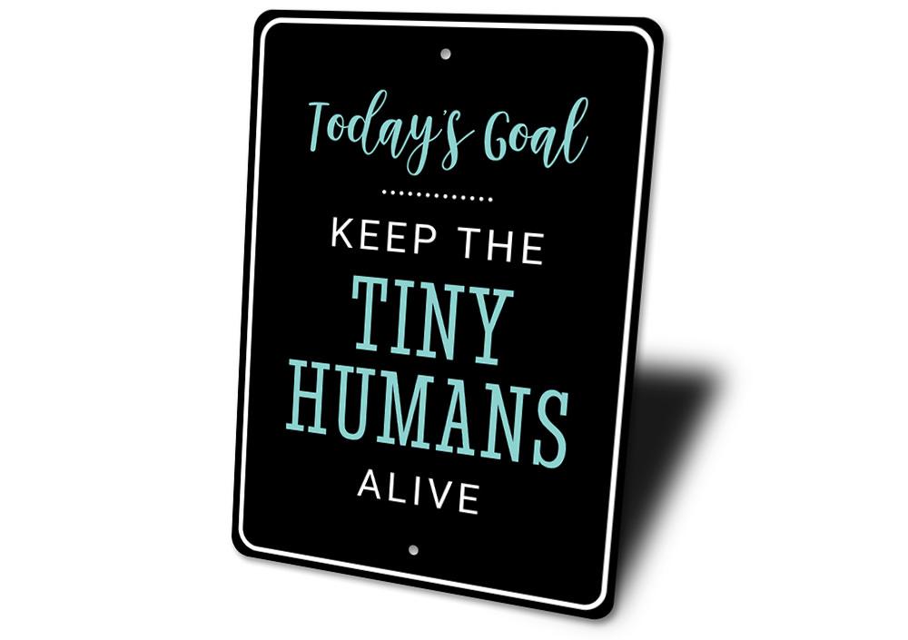 A decorative Tiny Humans Sign made of high-quality aluminum, featuring customizable text and pre-drilled holes for easy mounting.