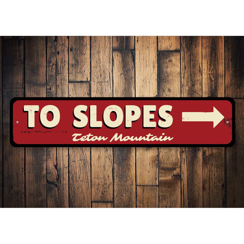 To Slopes Arrow Sign made of high-quality aluminum, featuring a ski-themed design, perfect for wall decor.