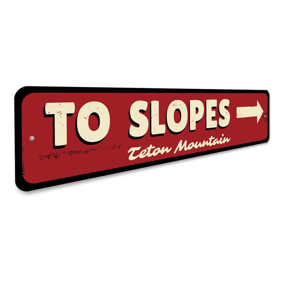 To Slopes Arrow Sign made of high-quality aluminum, featuring a ski-themed design, perfect for wall decor.