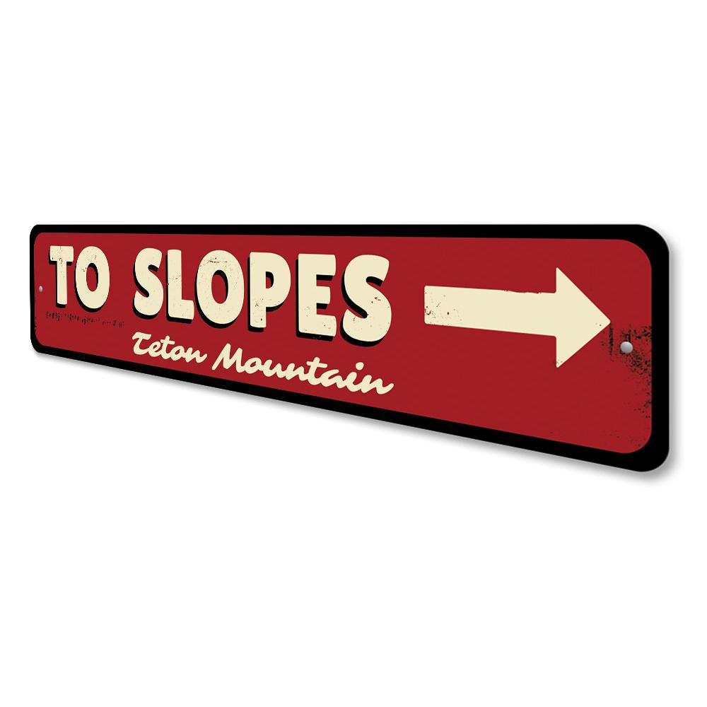 To Slopes Arrow Sign made of high-quality aluminum, featuring a ski-themed design, perfect for wall decor.