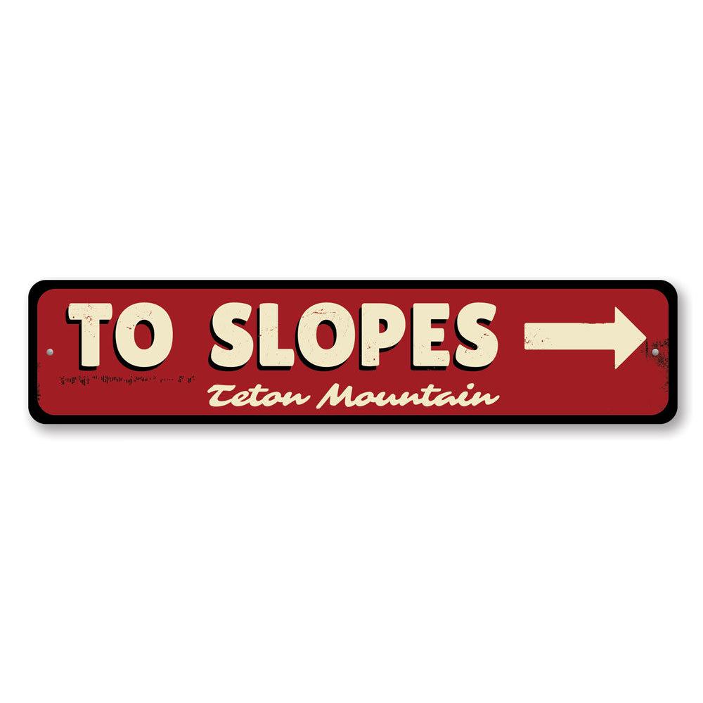 To Slopes Arrow Sign made of high-quality aluminum, featuring a ski-themed design, perfect for wall decor.