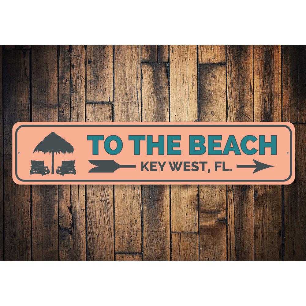 To the Beach Key West Sign made of high-quality aluminum, featuring a vibrant beach-themed design, perfect for coastal decor.