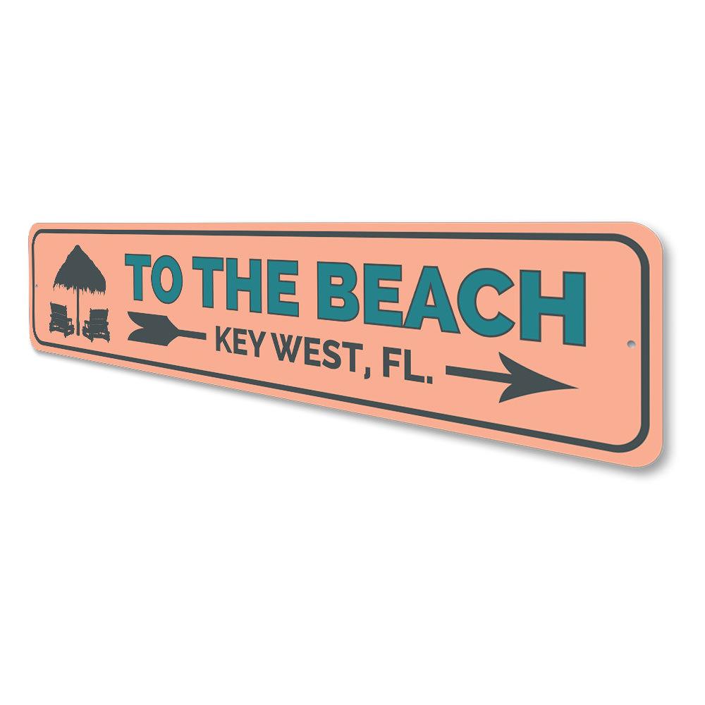 To the Beach Key West Sign made of high-quality aluminum, featuring a vibrant beach-themed design, perfect for coastal decor.