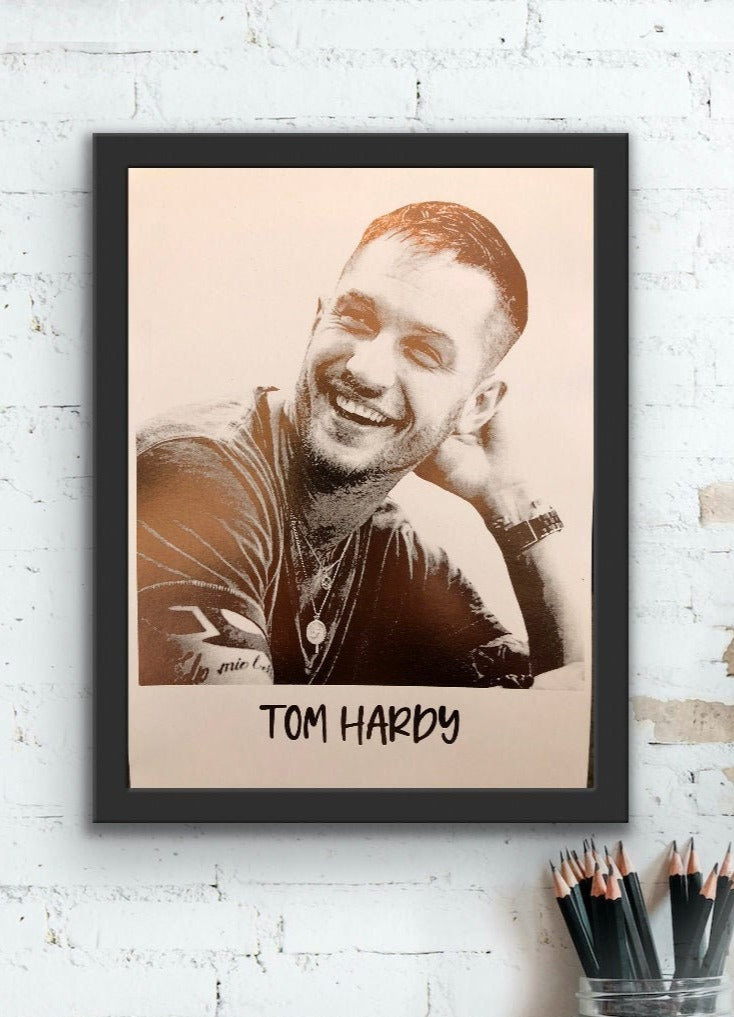 A beautiful foil print of Tom Hardy featuring a rose gold portrait on a white background.