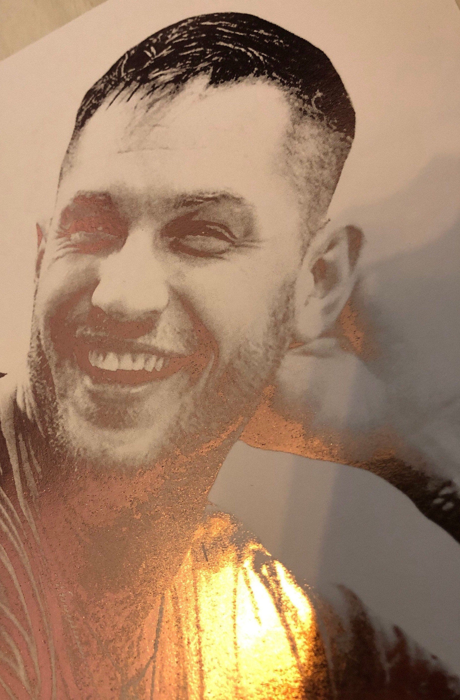 A beautiful foil print of Tom Hardy featuring a rose gold portrait on a white background.