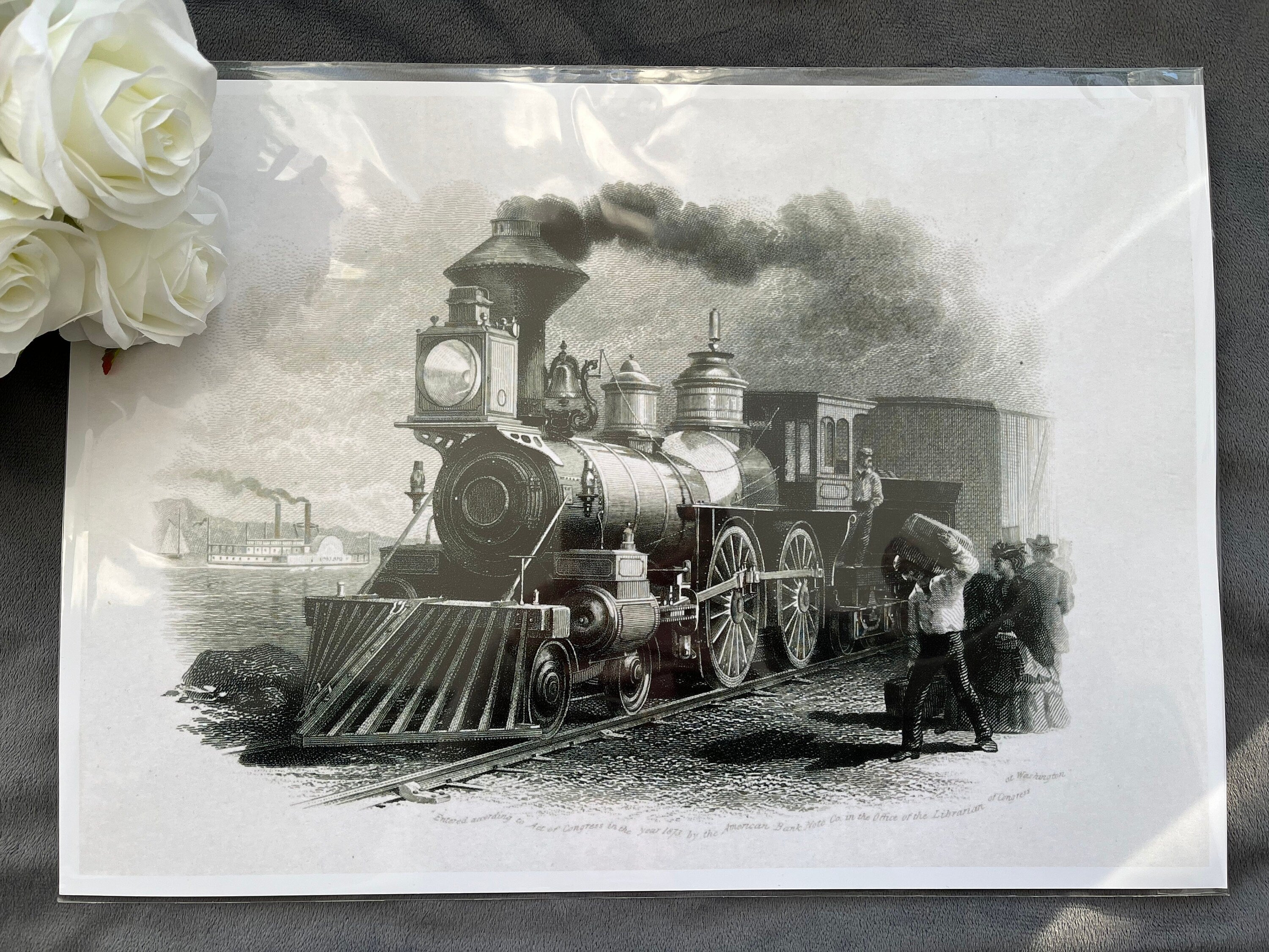 A classic black and white print of a train locomotive in action, showcasing vintage rail travel.