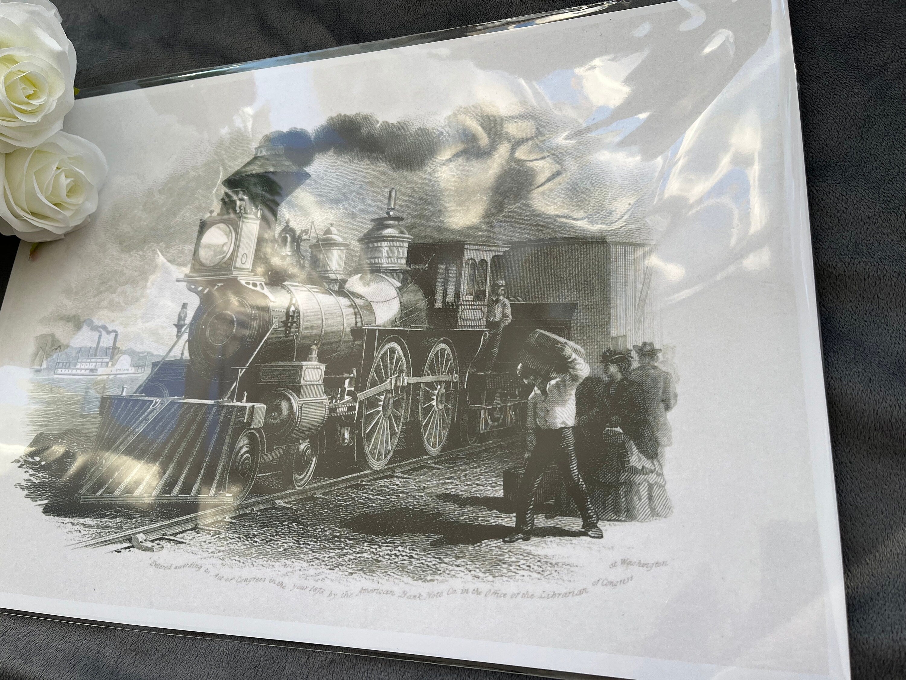 A classic black and white print of a train locomotive in action, showcasing vintage rail travel.