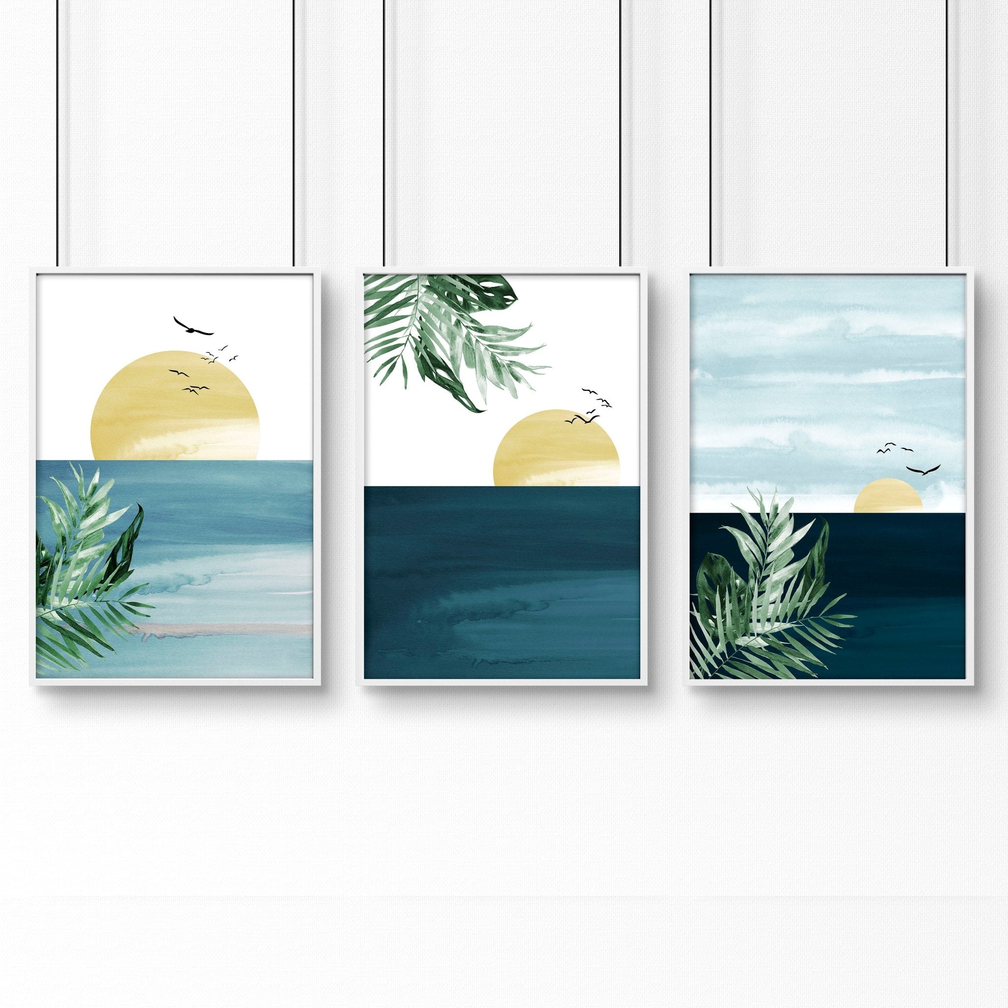 Set of 3 Tropical wall art prints featuring coastal designs in soothing blues and neutrals, perfect for home decor.