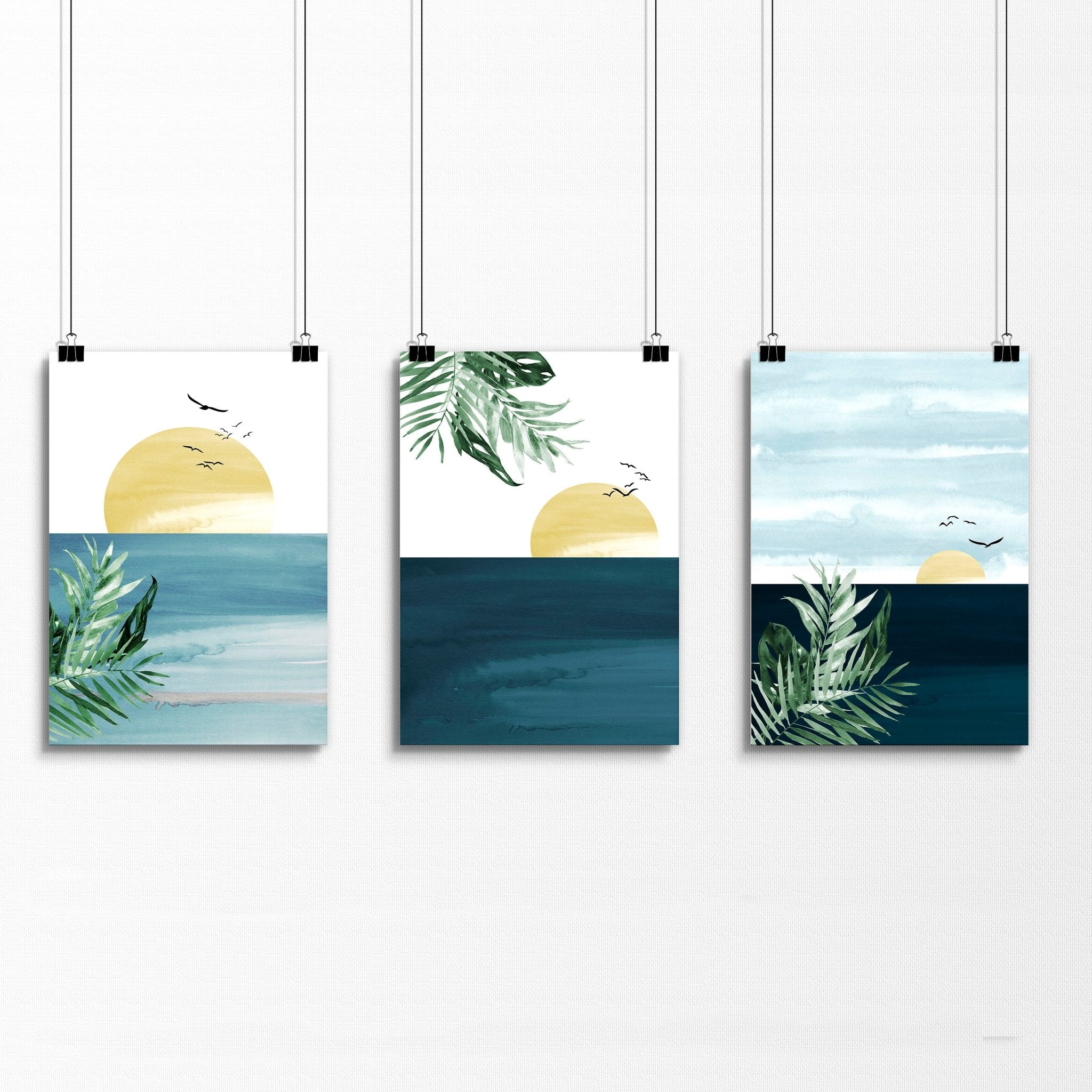 Set of 3 Tropical wall art prints featuring coastal designs in soothing blues and neutrals, perfect for home decor.