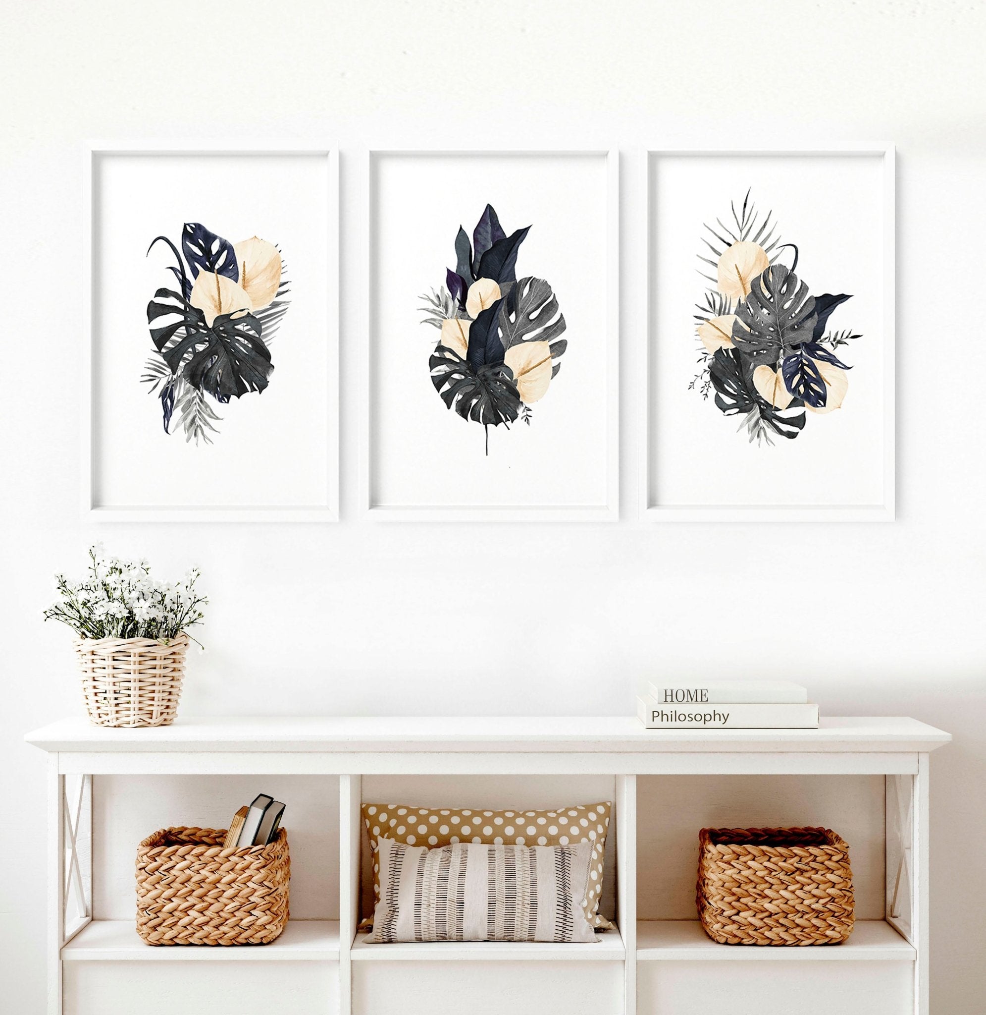 Set of 3 tropical wall art prints featuring watercolour monstera leaves and blush flowers in muted blue hues, perfect for modern decor.