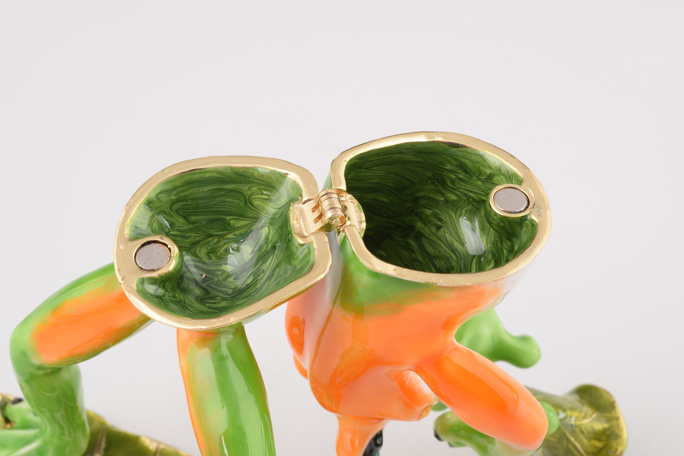 A beautifully crafted Trumpet Playing Frog trinket box, featuring vibrant enamel and sparkling Austrian crystals, plated with 24K gold.