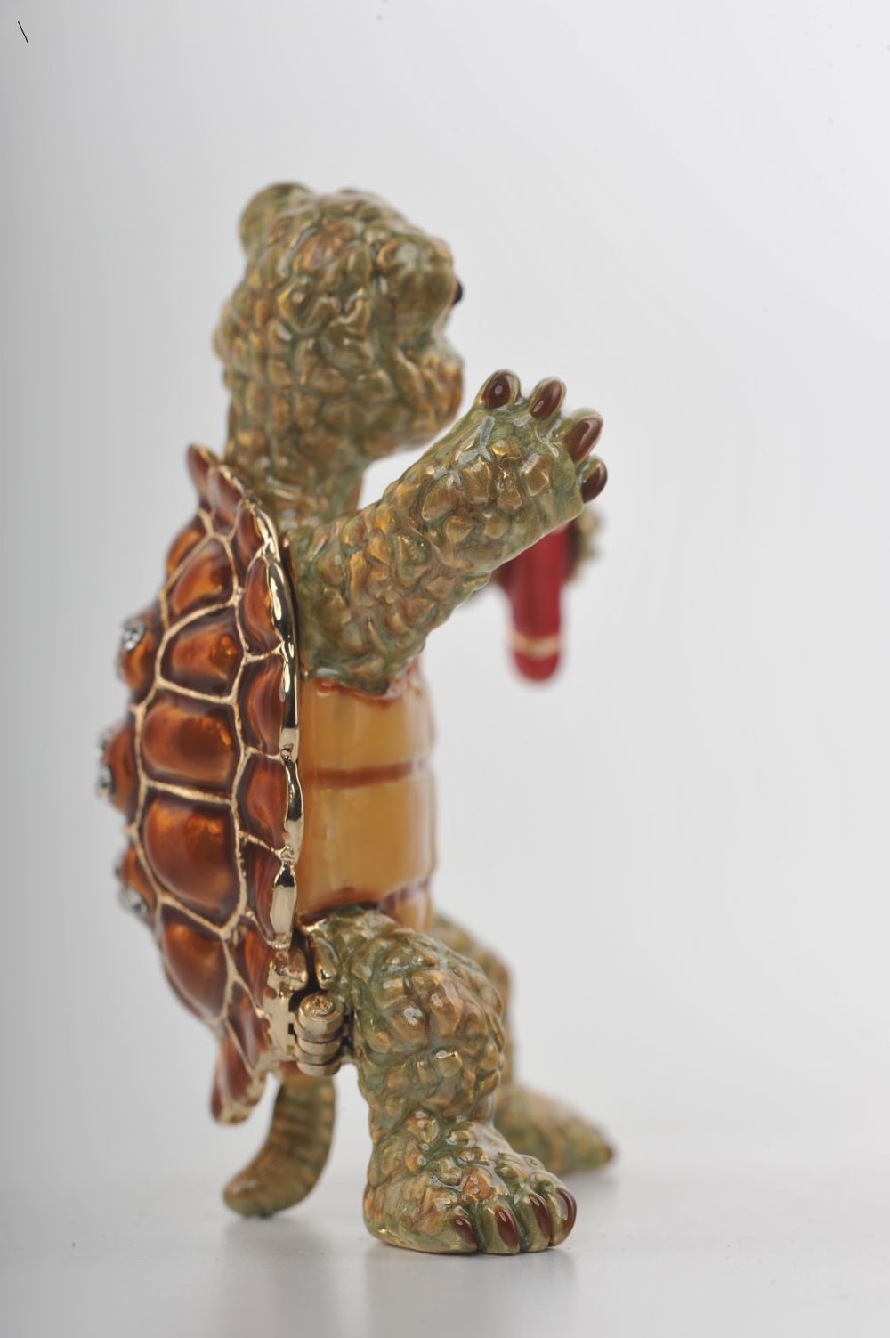 Handmade turtle trinket box playing saxophone, adorned with Austrian crystals and 24K gold plating.