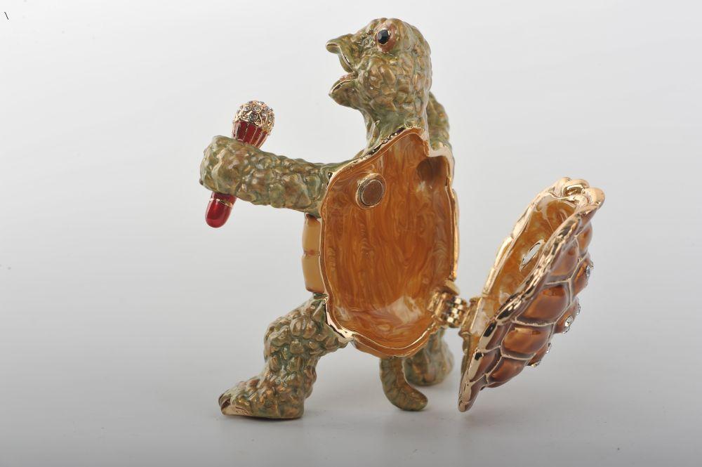 Handmade turtle trinket box playing saxophone, adorned with Austrian crystals and 24K gold plating.