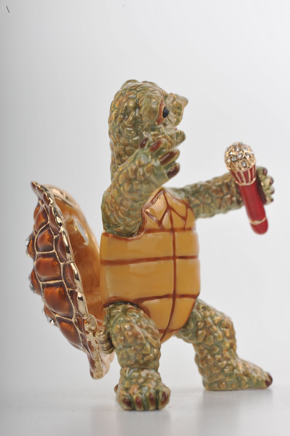 Handmade turtle trinket box playing saxophone, adorned with Austrian crystals and 24K gold plating.