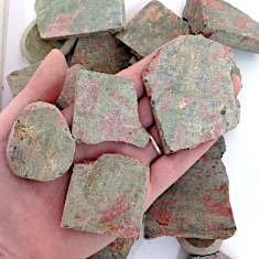 Unakite Rough Slabs showcasing vibrant green and pink hues, perfect for healing and meditation.