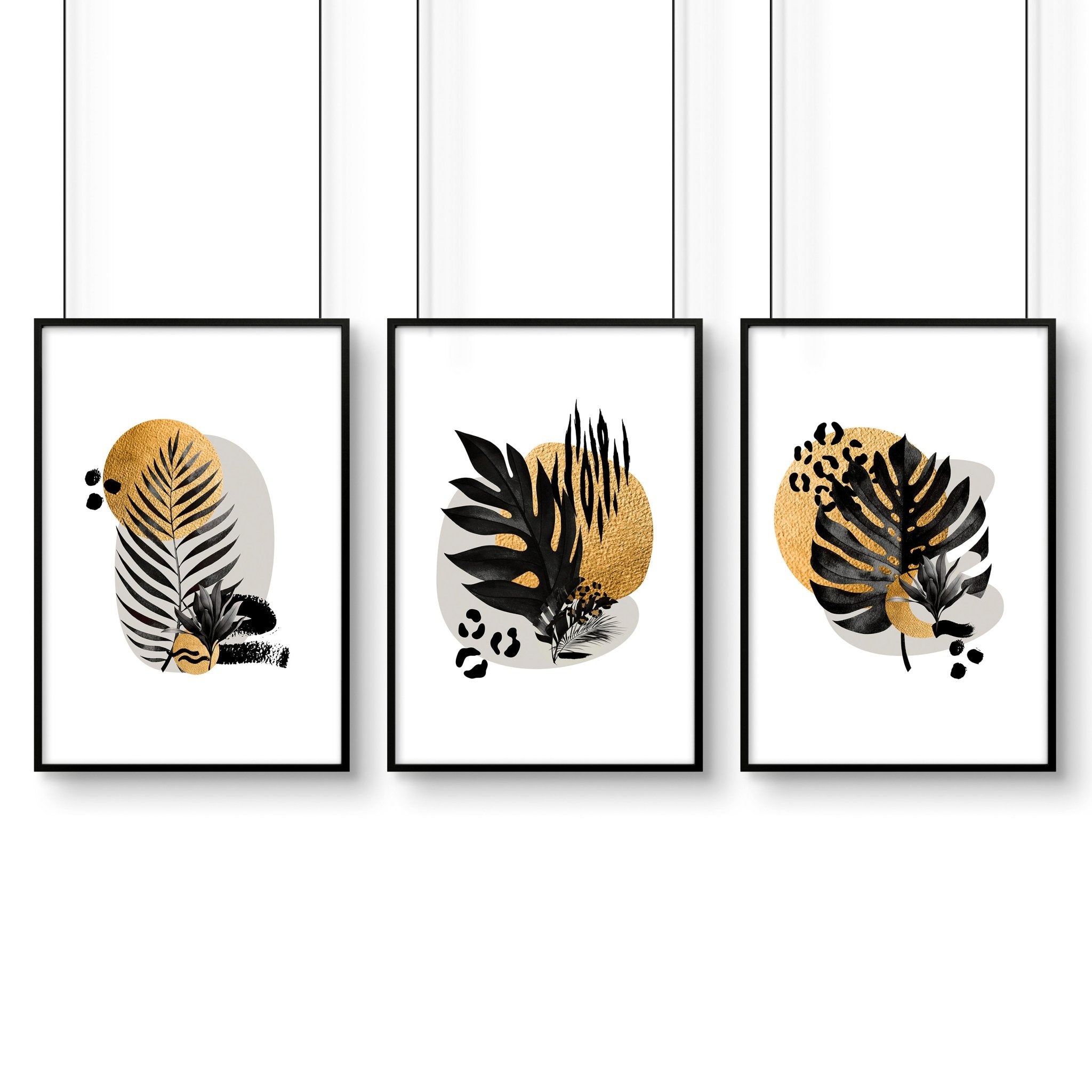 Set of 3 framed wall art prints featuring tropical botanical designs in gold, black, and grey, perfect for living room decor.