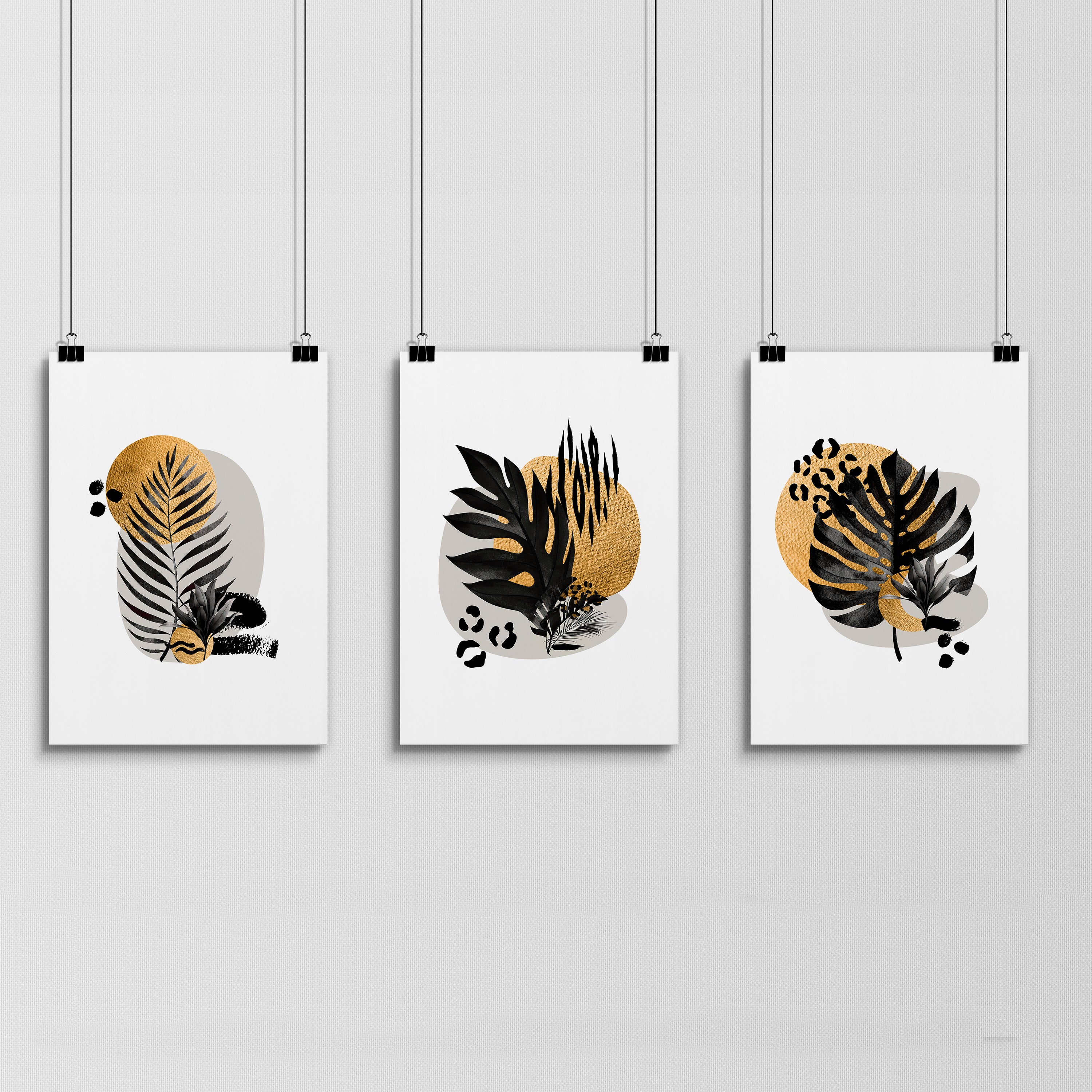 Set of 3 framed wall art prints featuring tropical botanical designs in gold, black, and grey, perfect for living room decor.