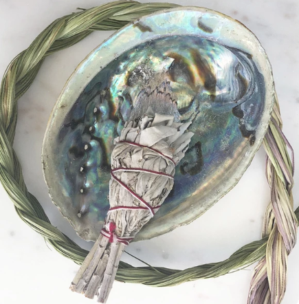 An unpolished abalone shell showcasing natural imperfections and iridescent colors, ideal for smudging rituals.