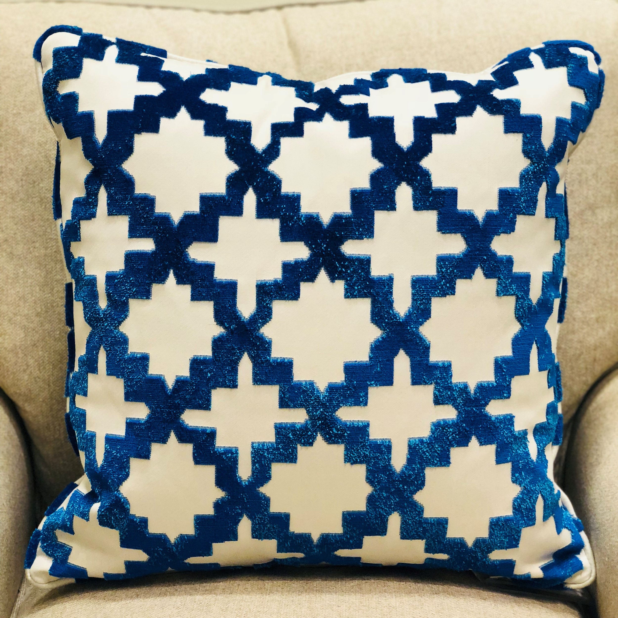 Luxurious blue and off white geometric throw pillow with French medallion design, featuring a soft velvety texture and piping edge.